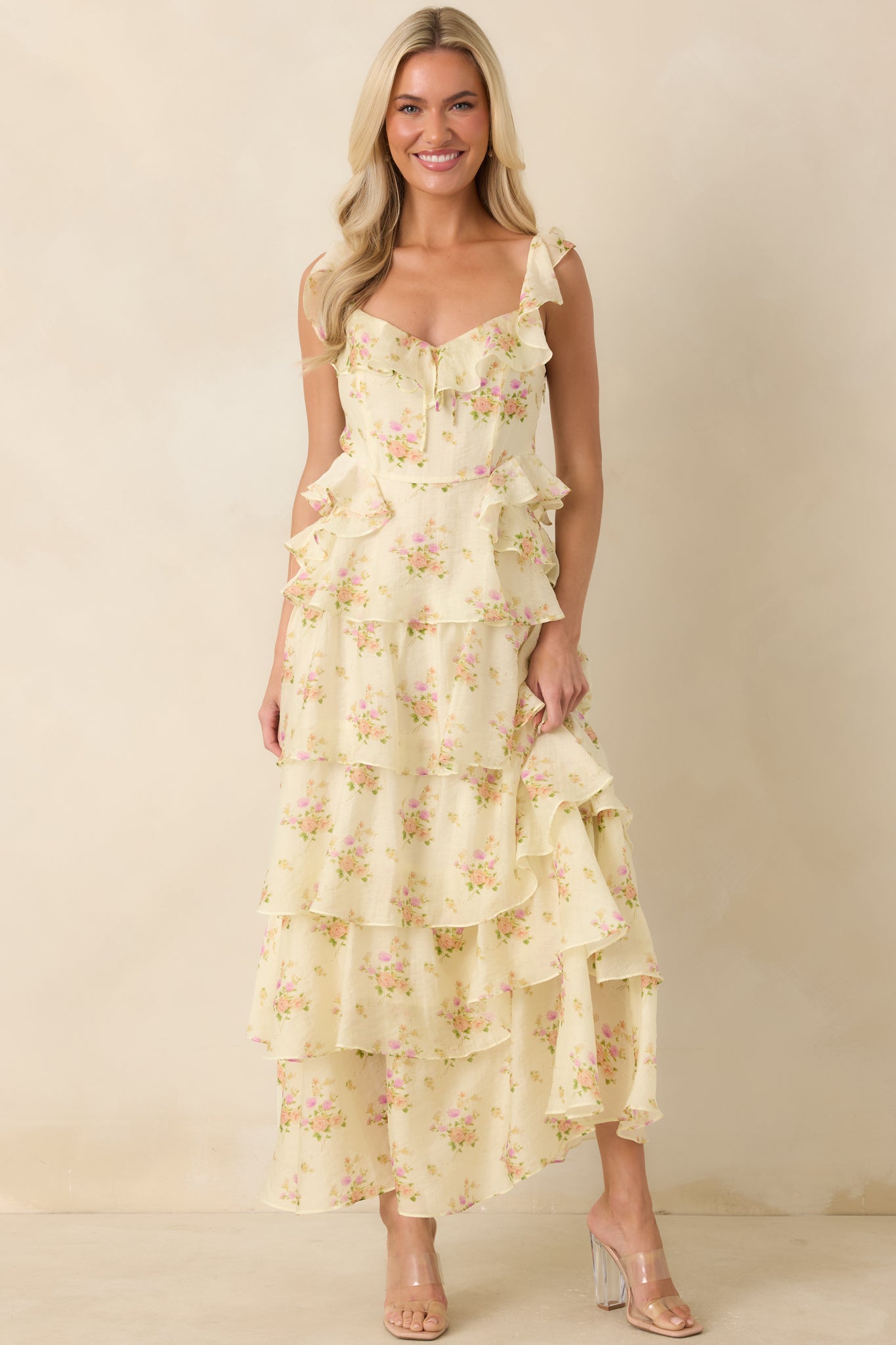 Lightweight woven maxi dress showcasing a delicate floral print, ruffle waist accents, and flowing tiers.
