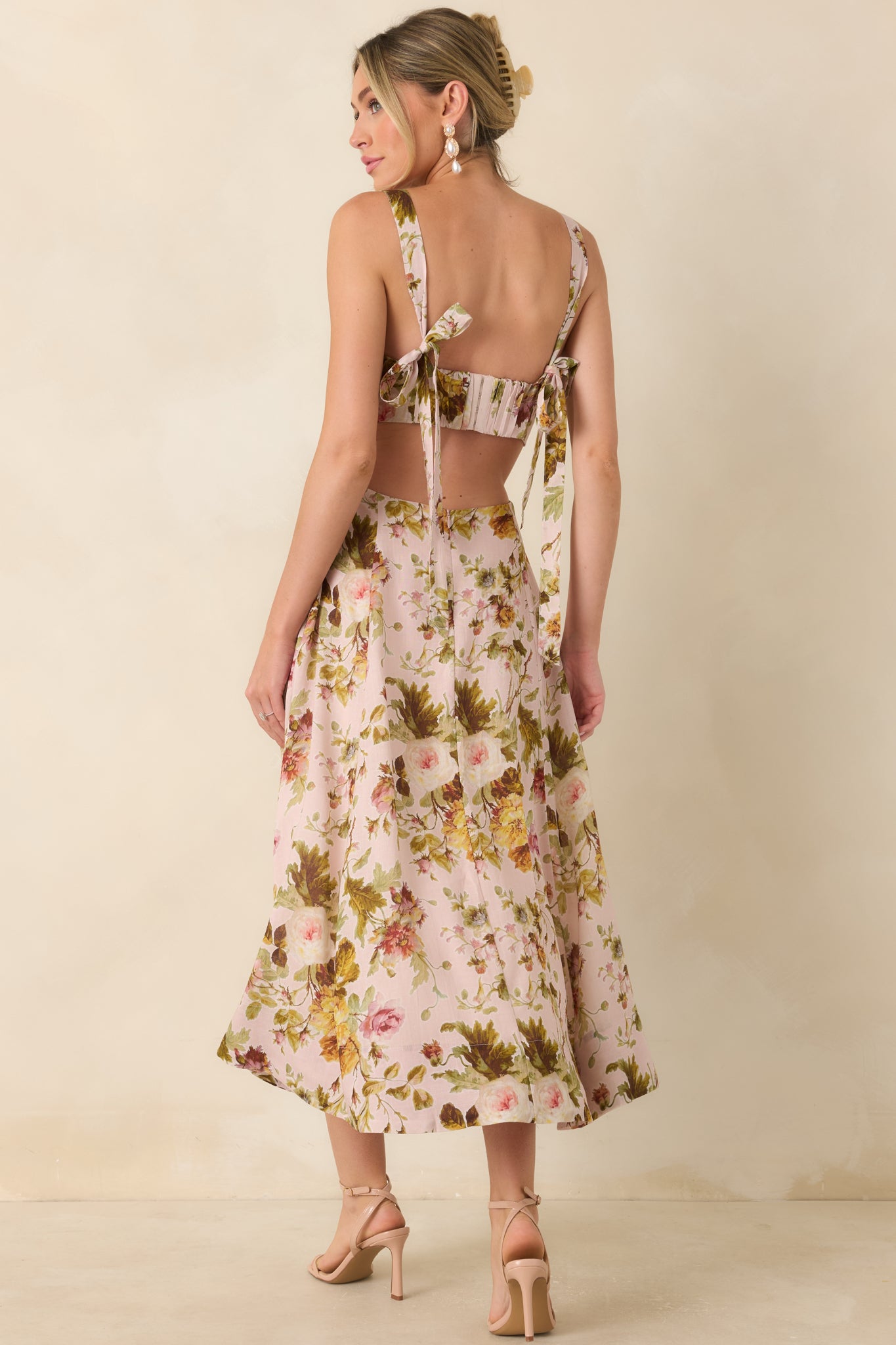 Back view of the floral midi dress featuring an open back cutout and adjustable hook-and-eye closure.