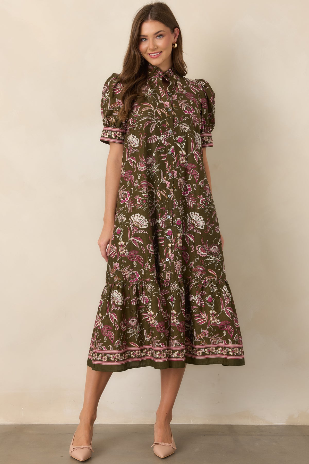 Floral midi dress featuring decorative borders along the short sleeve cuffs and hem.
