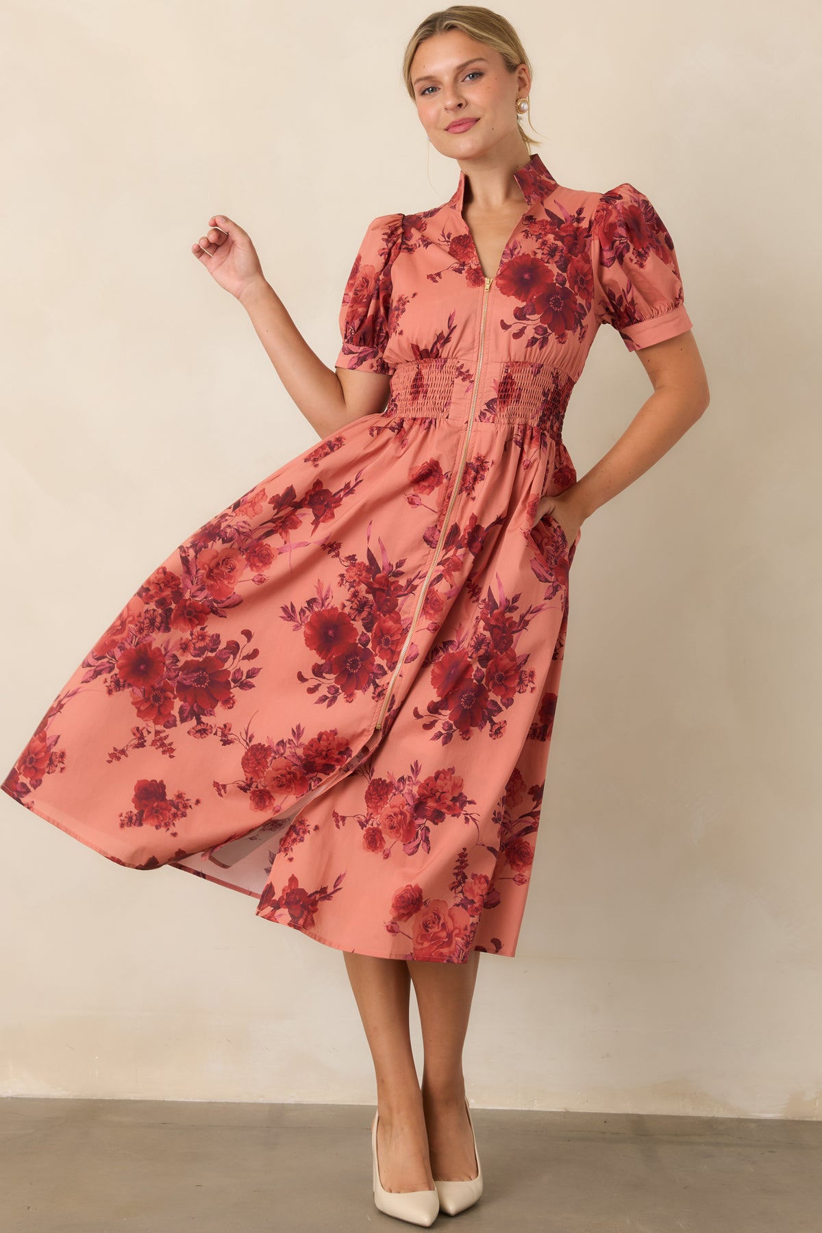 Floral midi dress featuring short puff sleeves, a stand collar, and contrasting gold-tone zipper.