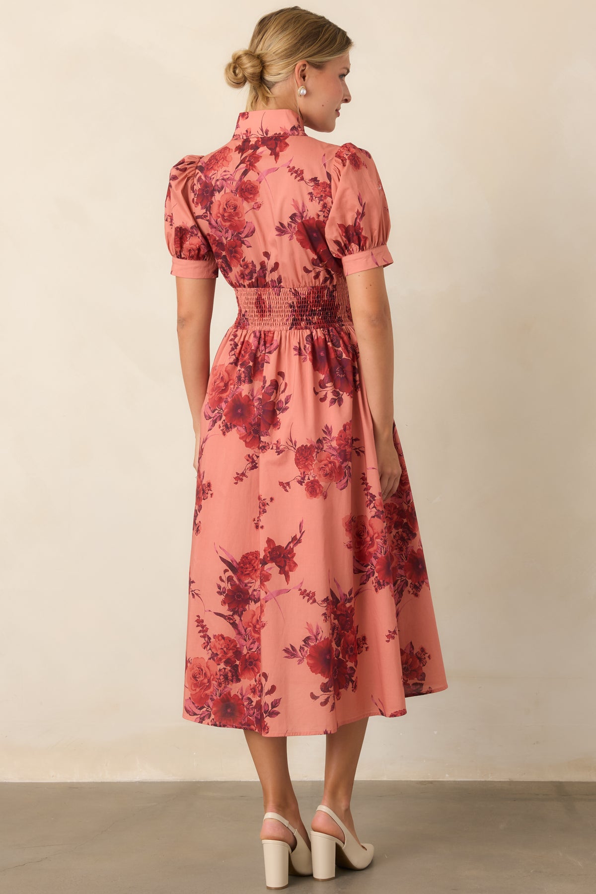 Rear of the floral midi dress showcasing the smocked waist and softly flared A-line skirt.
