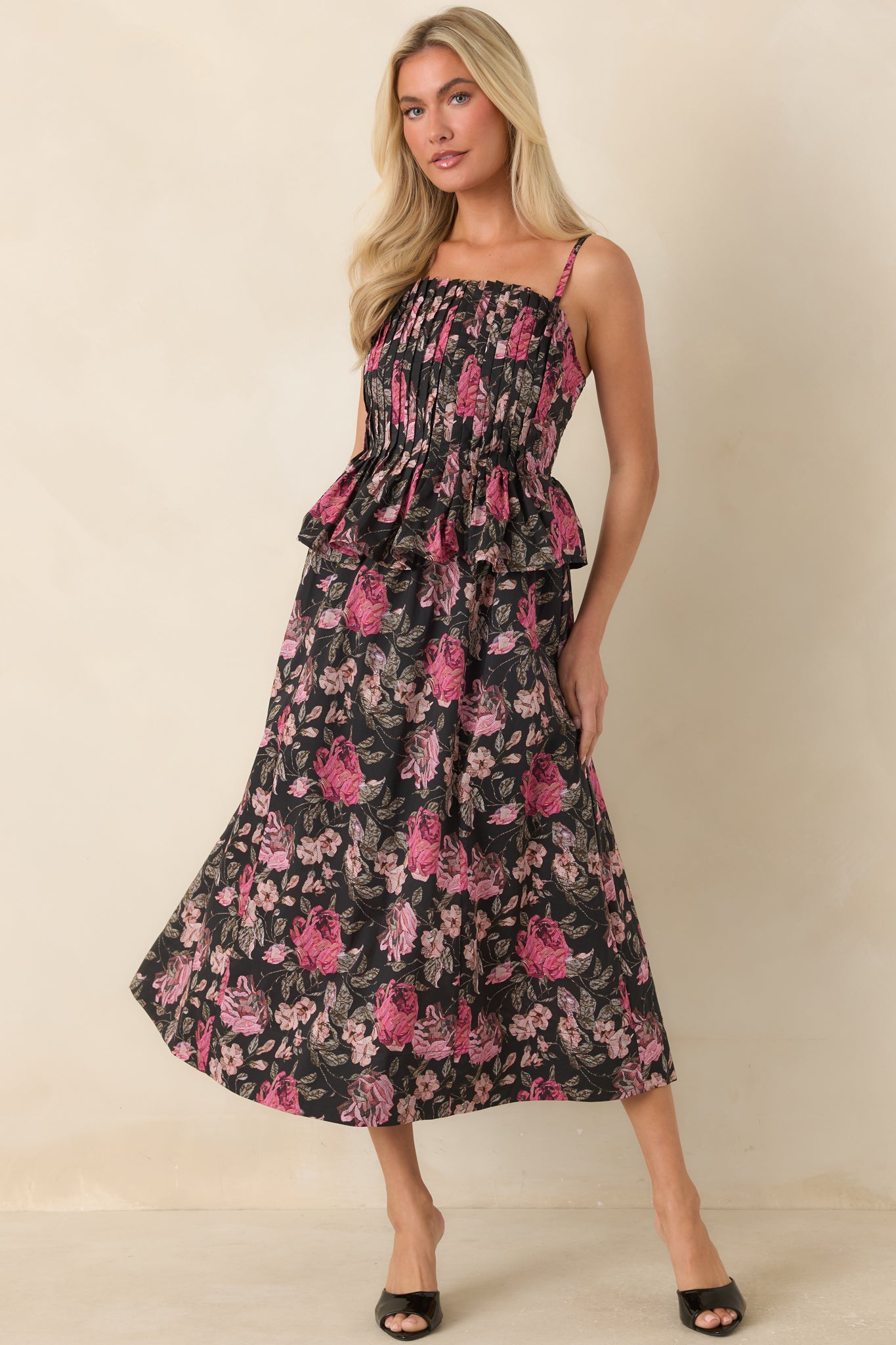Floral midi dress showcasing a full skirt, delicate shoulder straps, and a softly structured bodice.