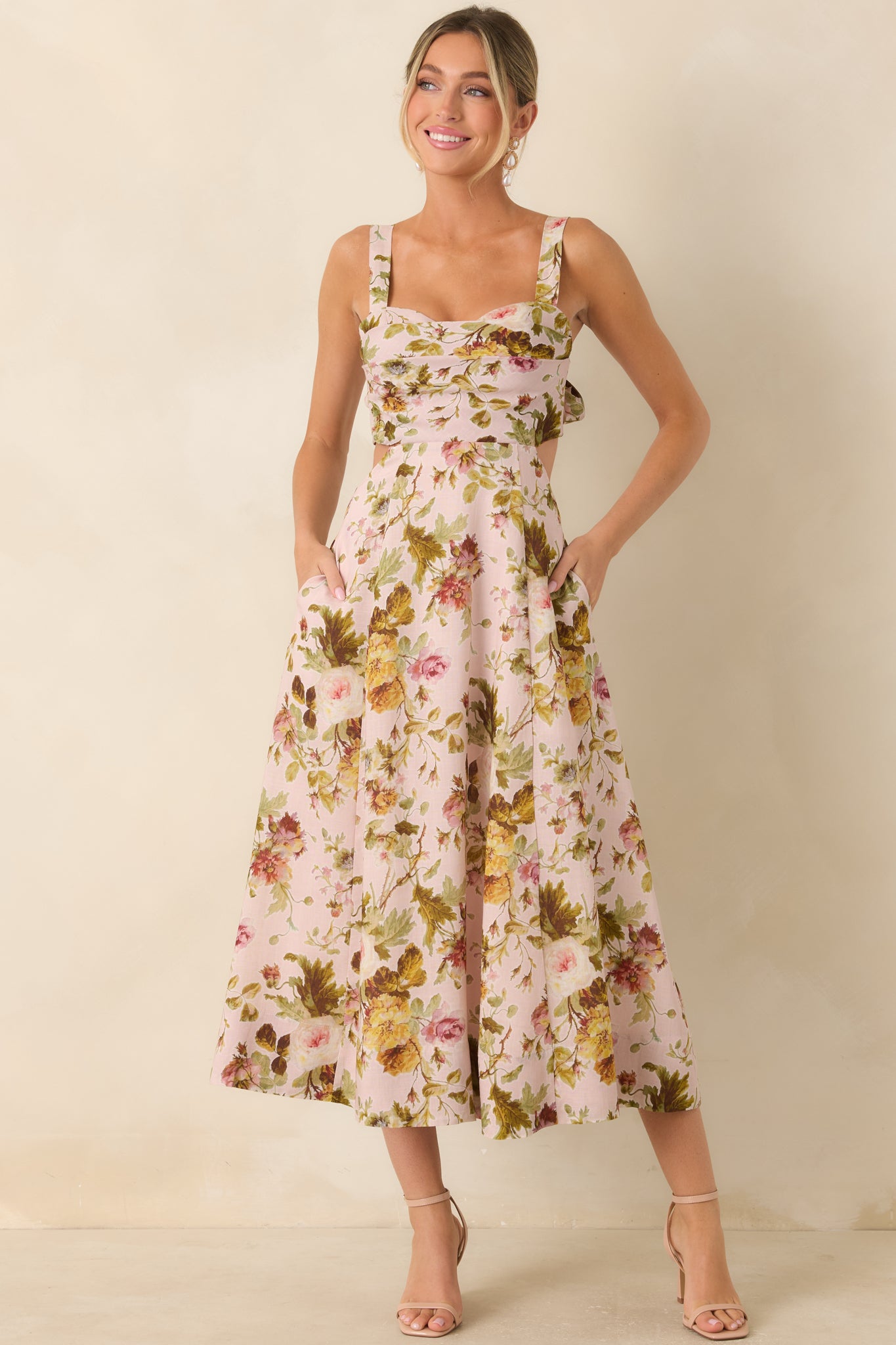 Floral midi dress featuring a sweetheart neckline, self-tie shoulder straps, and a flowing fit-and-flare silhouette.