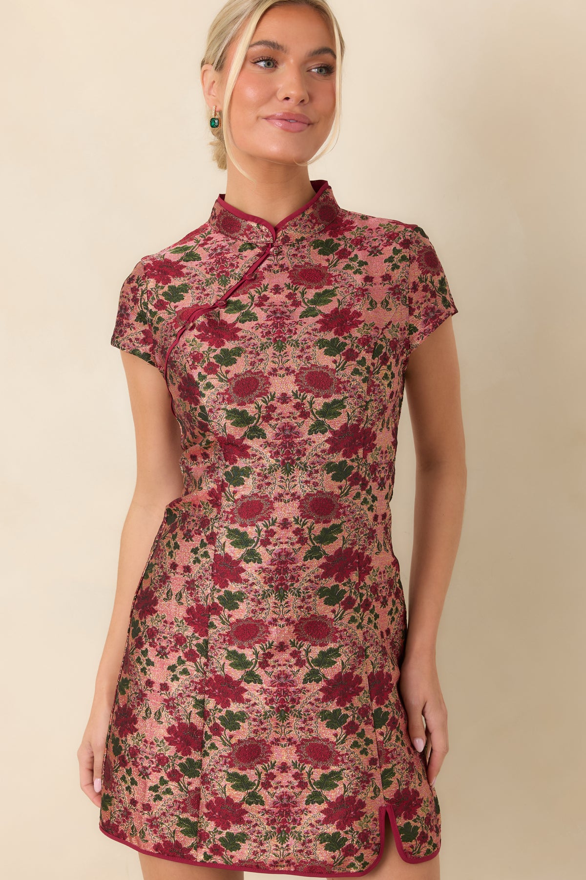 Shaped waist seams define the fitted bodice above the gently flared floral mini skirt.