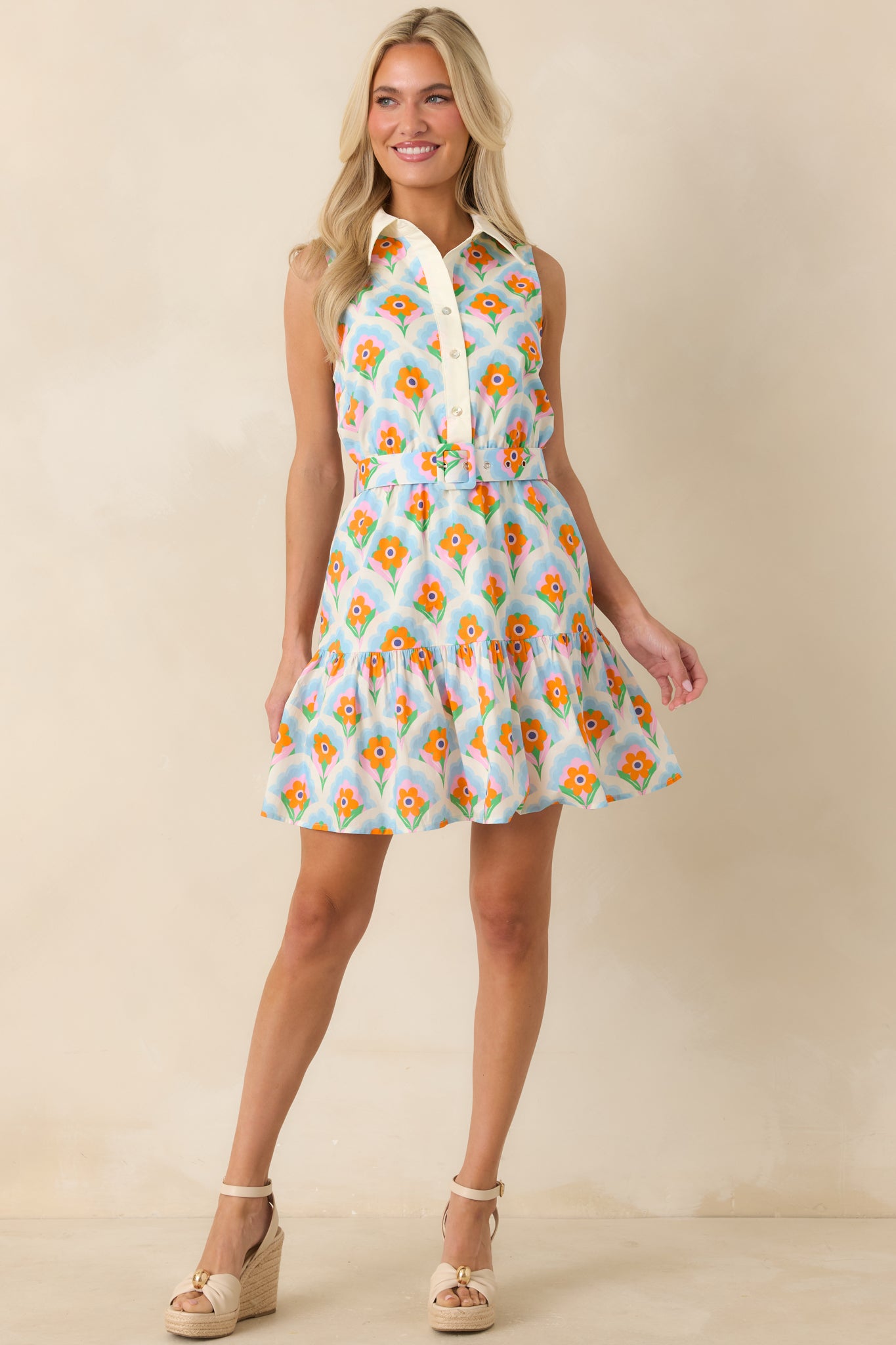 Lightweight floral mini dress with a collared neckline, removable matching belt, and flouncy ruffle hem.