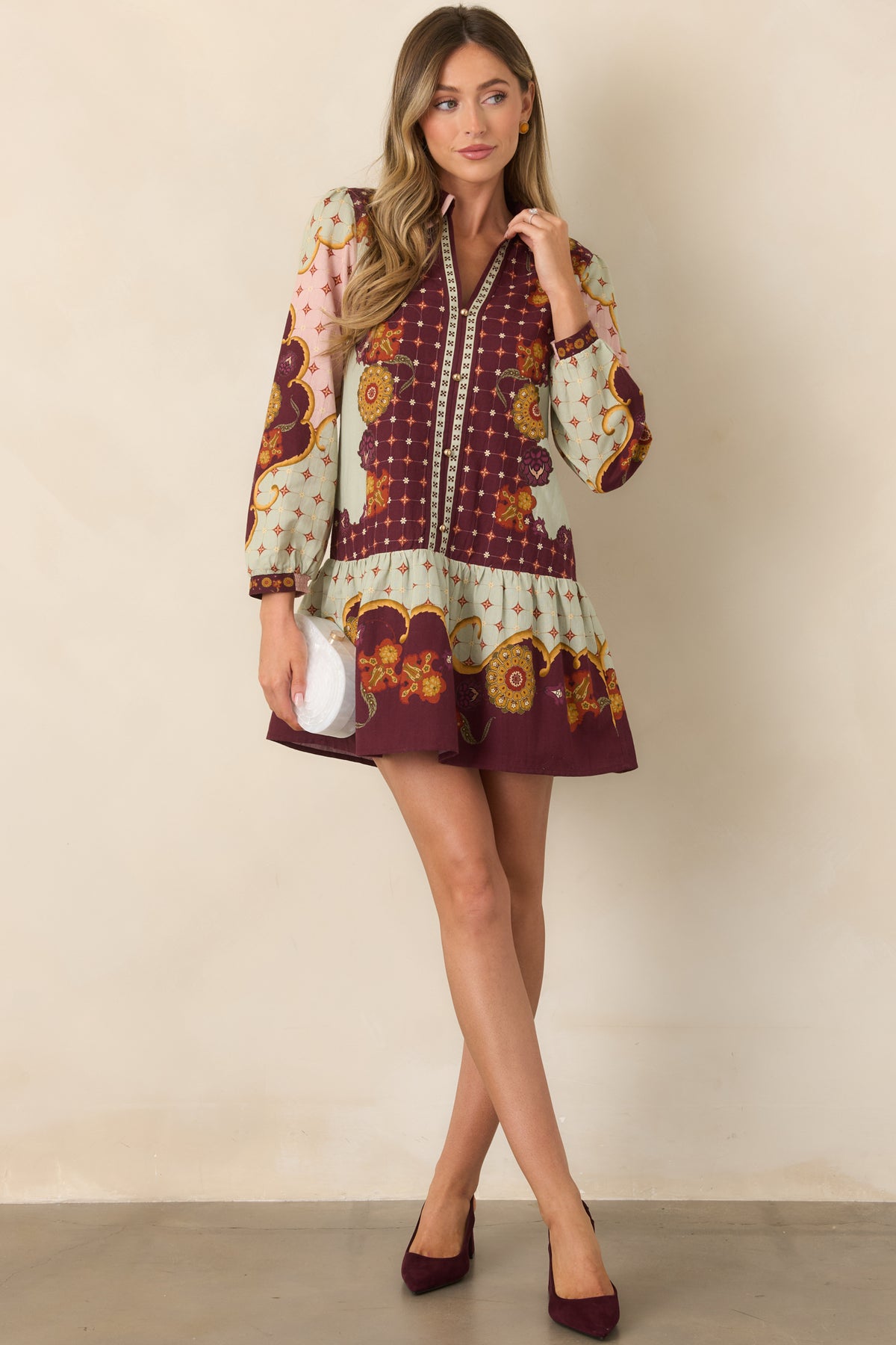 Patterned mini dress with a pink-trimmed pointed collar, gold-tone button placket, and blouson sleeves.