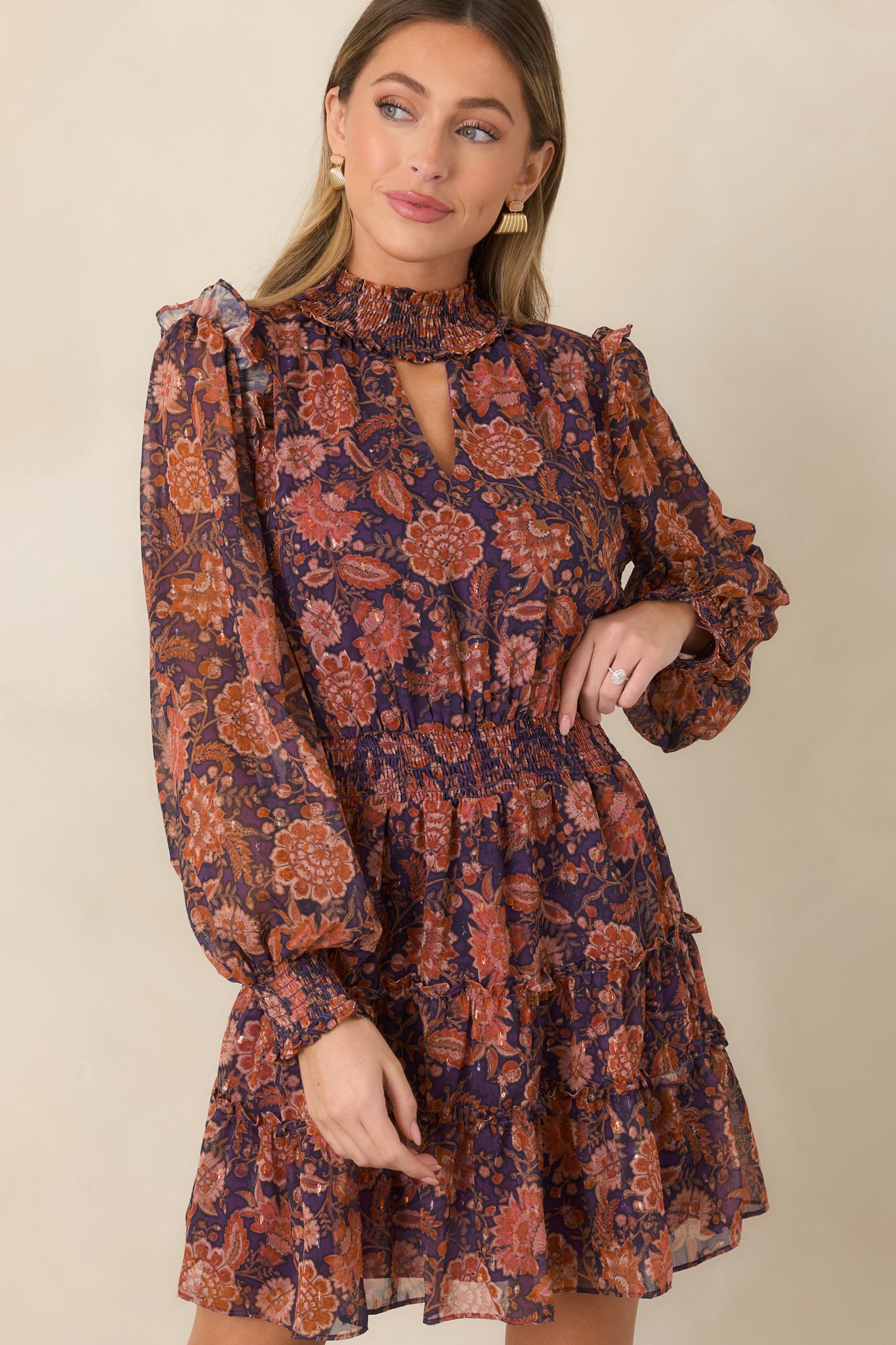 Detailed view of the softly puffed long sleeve with a smocked cuff and colorful floral print.