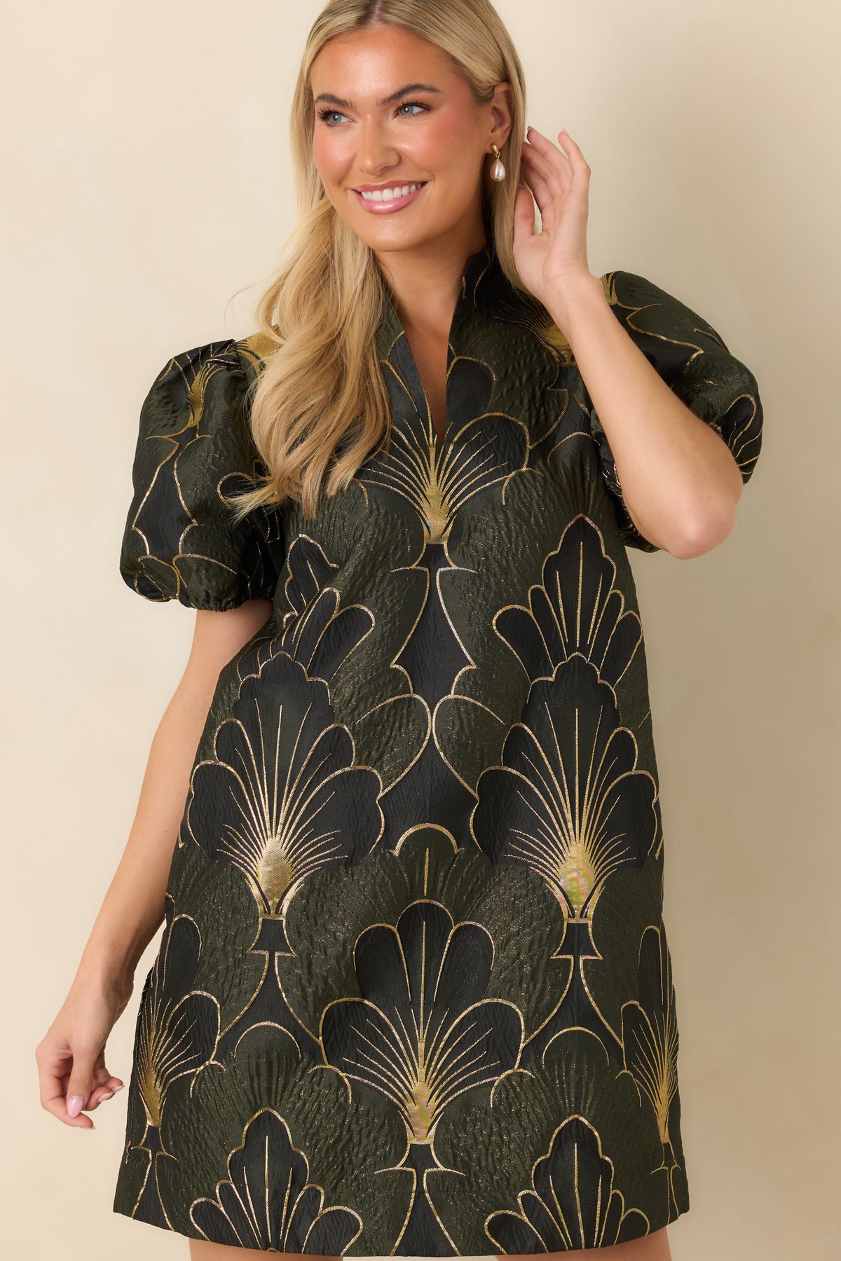 Short puff sleeves add volume to the mini dress with oversized black and gold florals.