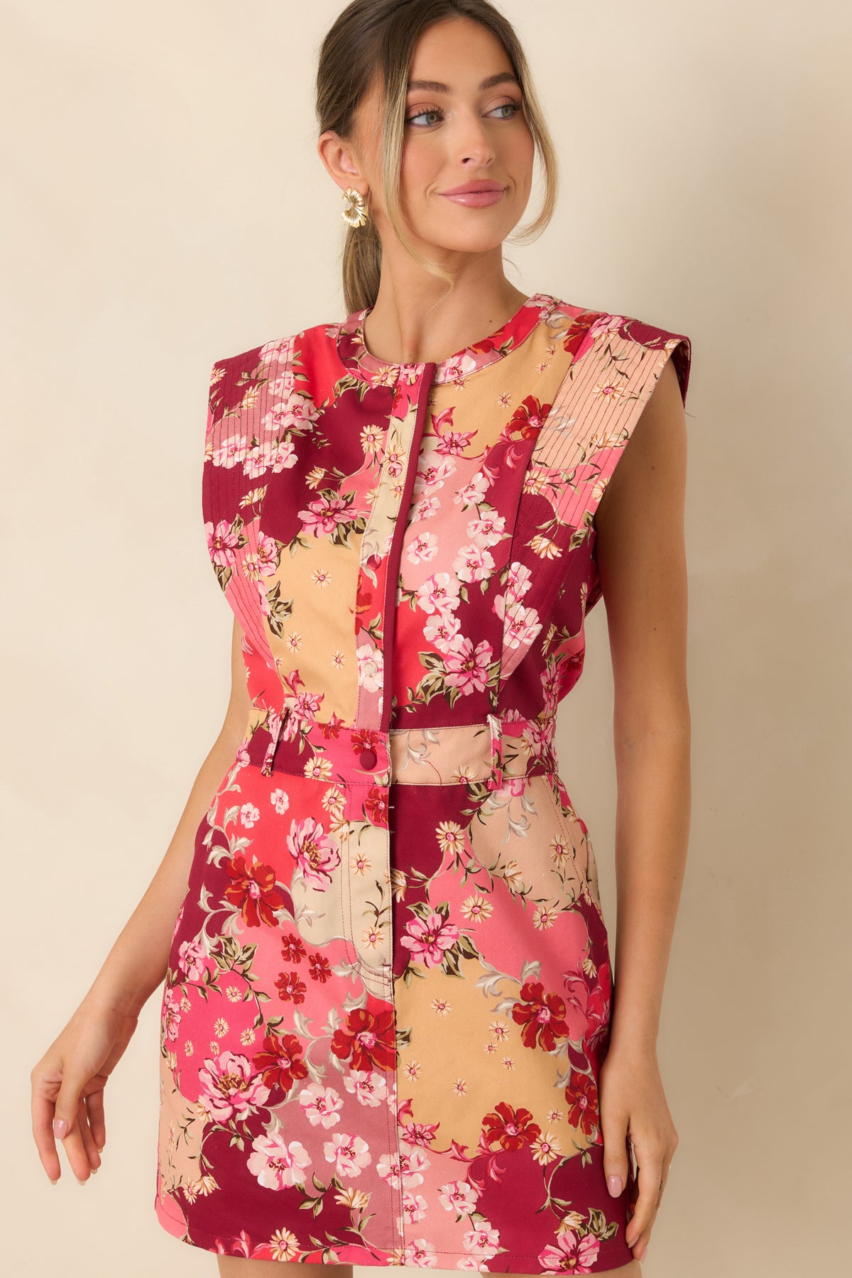 Rows of stitching detail the wide shoulder panels of the multicolor floral mini dress.