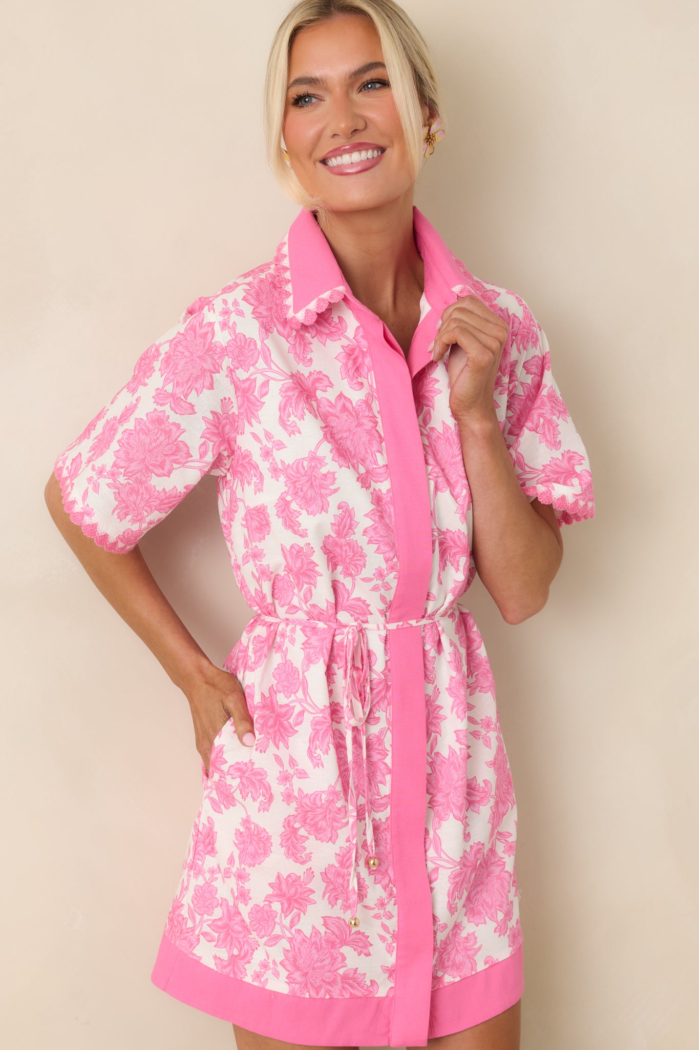Floral mini dress with collared neckline, button-front design, and bold contrast trim.