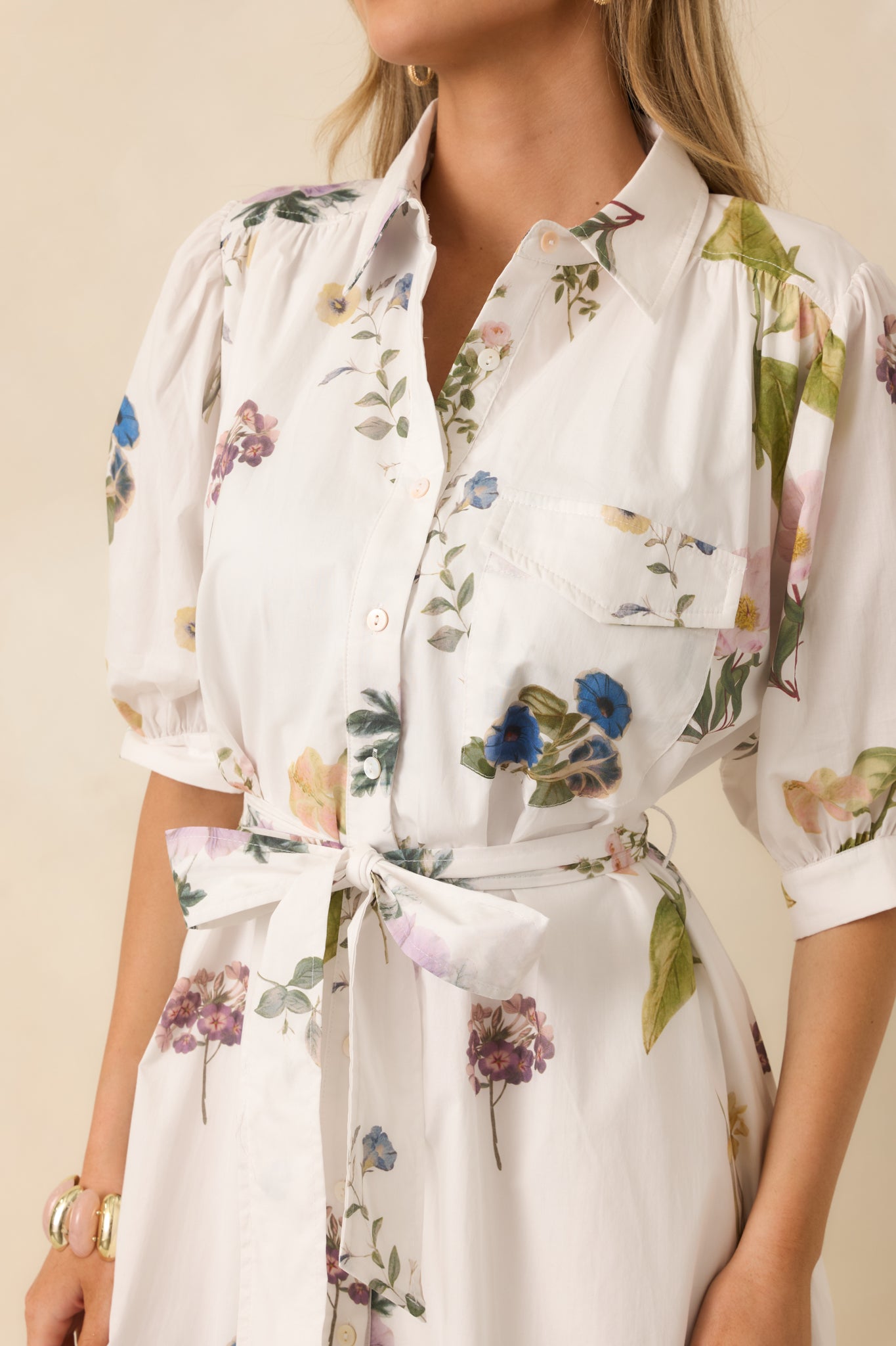 Close detail of the floral print and button placket on soft, airy woven cotton.