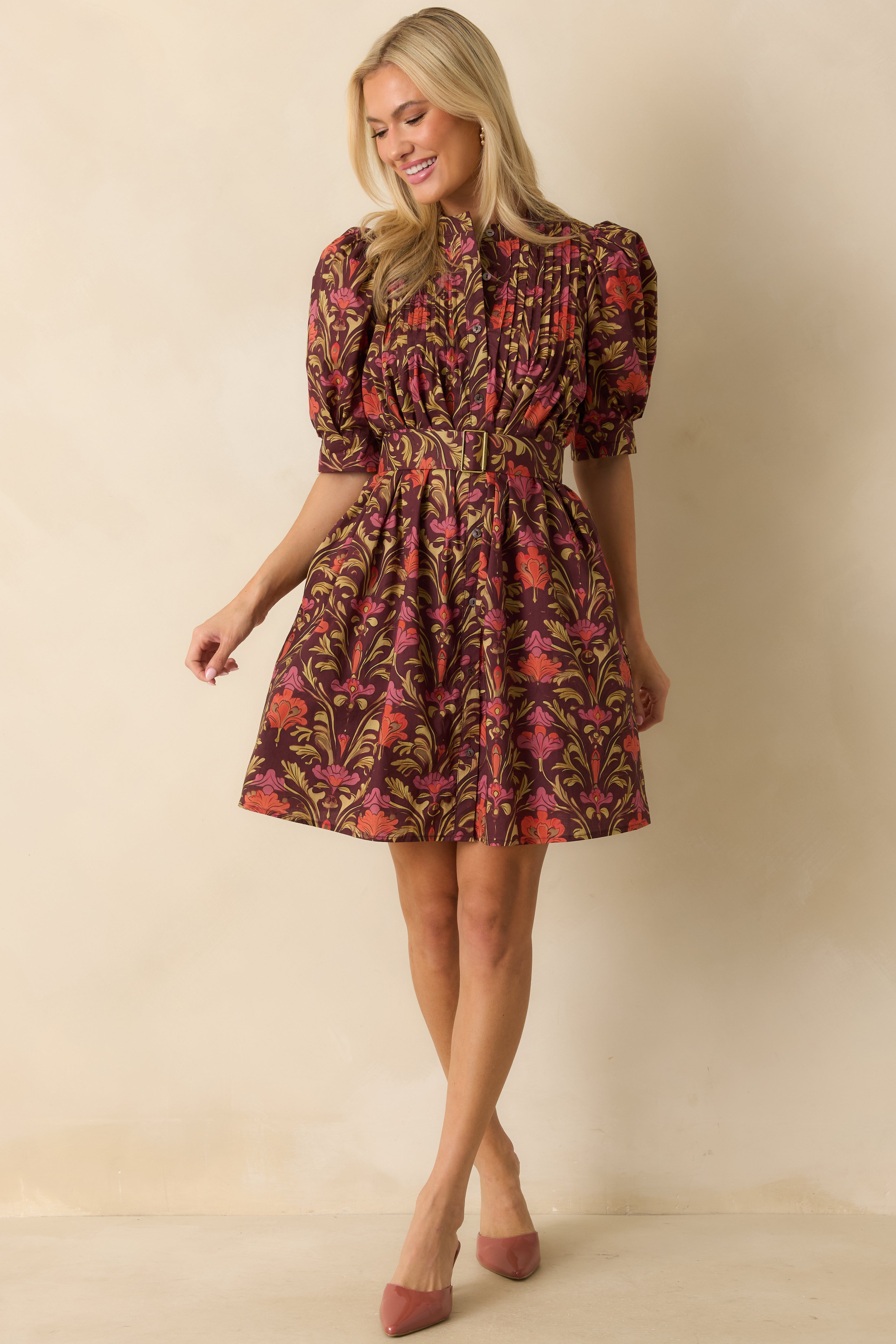 Full view emphasizing the side pockets and flowy mini length of the floral print dress.