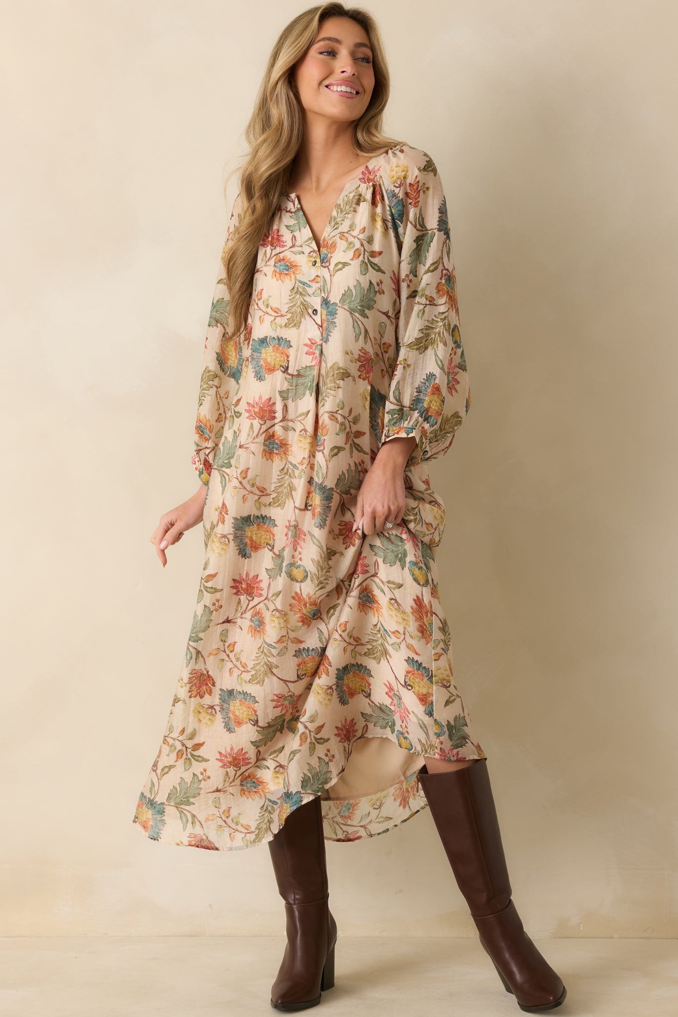 The floral print stands out on this ecru maxi dress, complete with button-cuffed sleeves and a breezy fit.
