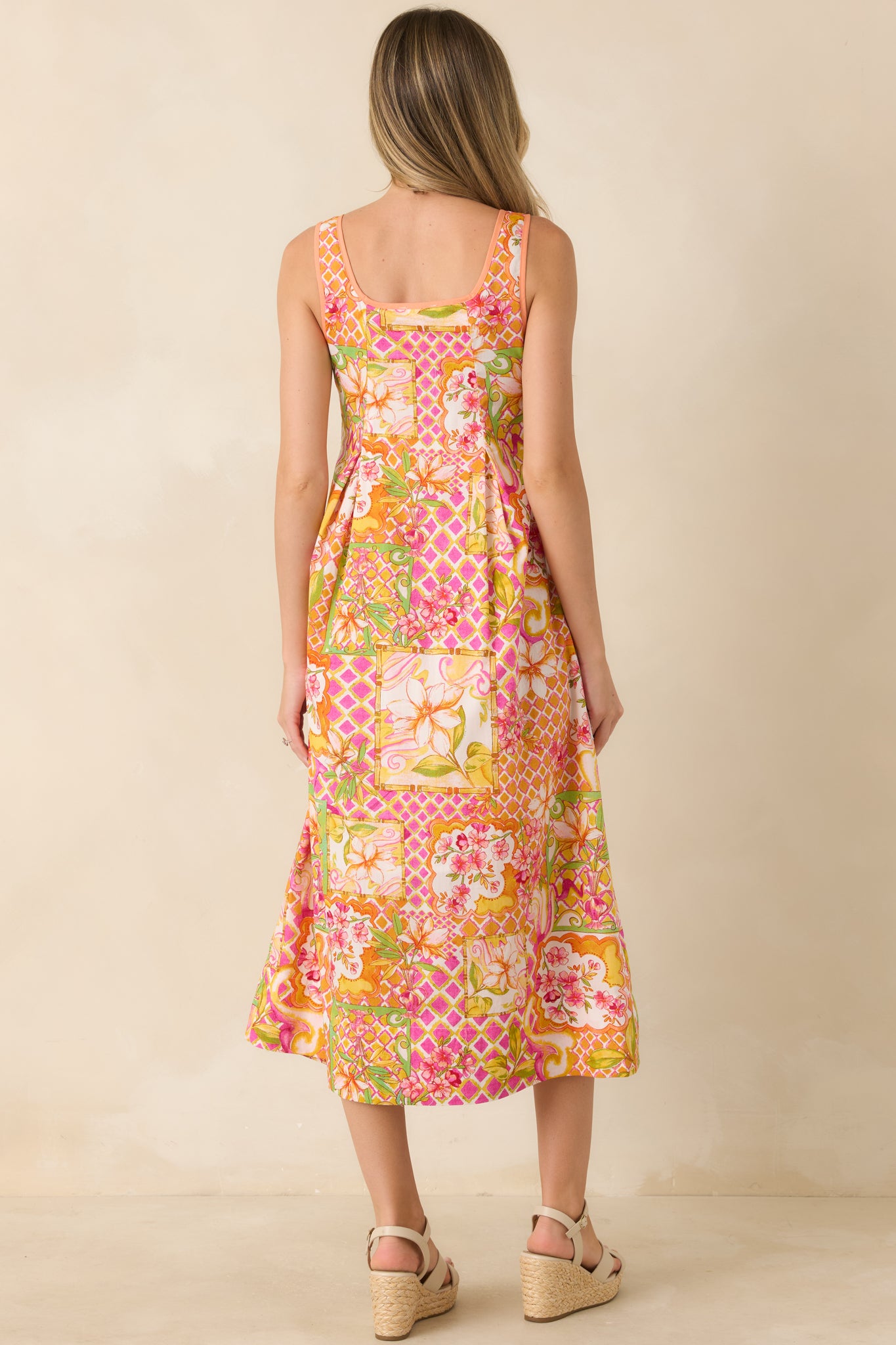 Back view of the floral print midi dress showcasing the fully lined construction, A-line silhouette, and vibrant patchwork-inspired pattern.