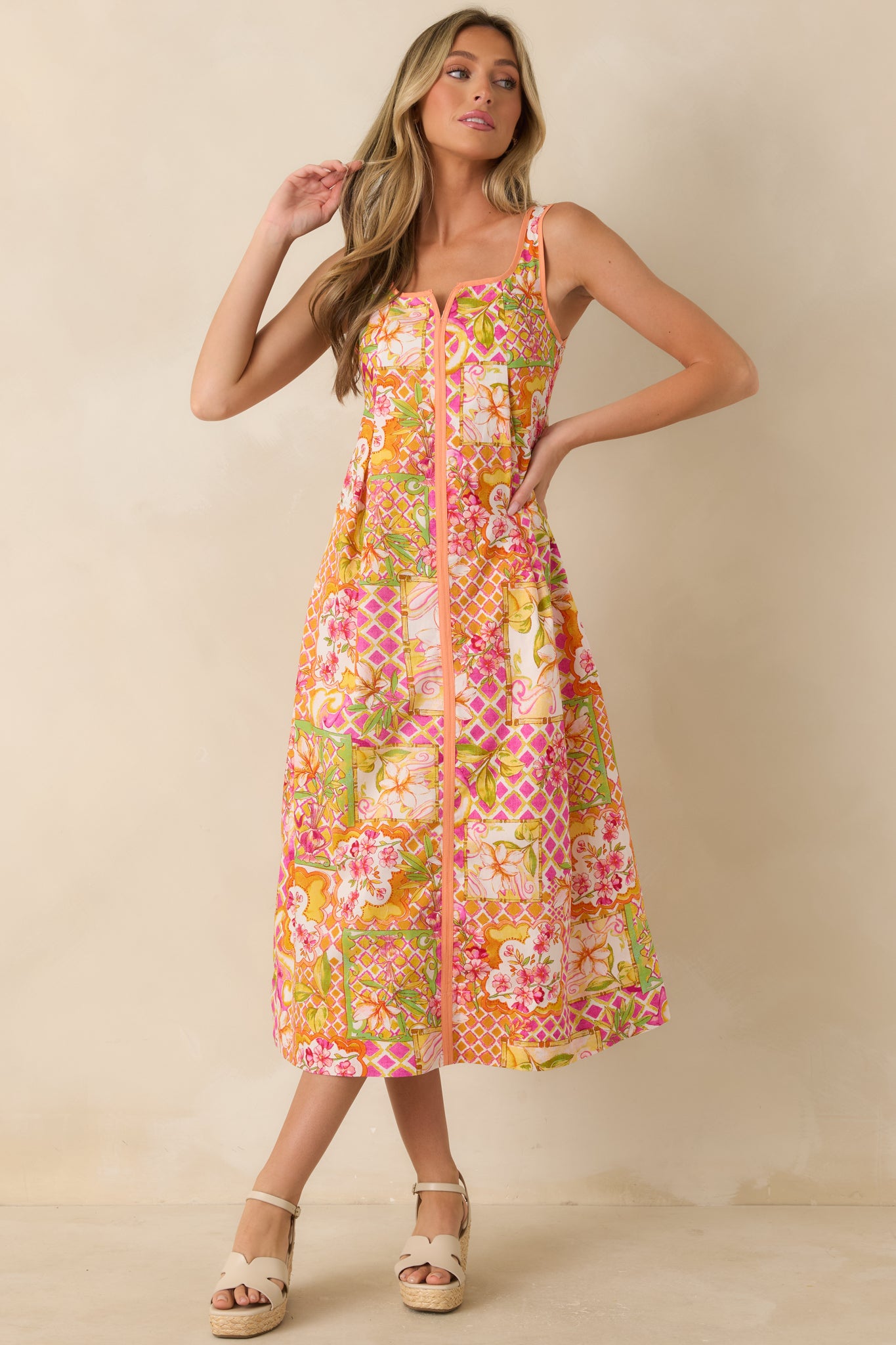 Floral print midi dress crafted from 100% cotton, featuring a vibrant patchwork-inspired design, square neckline with a notched detail, and a flattering A-line silhouette.