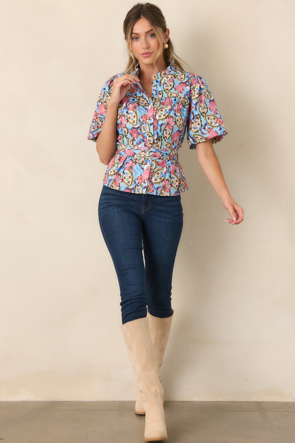 Floral printed top with a removable fabric belt, stitched detailing, and gentle fullness through the bodice.