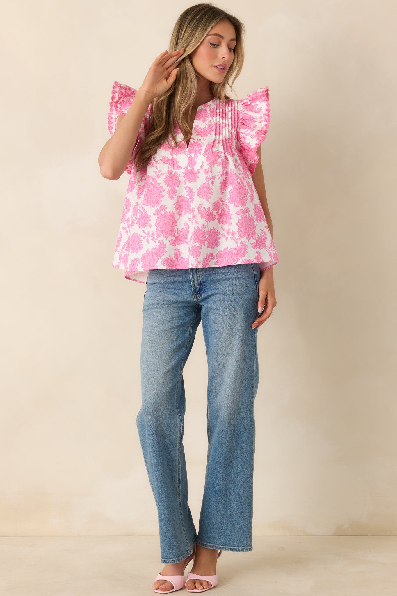 Floral print top with split neckline, pleated yoke, and airy, relaxed silhouette.
