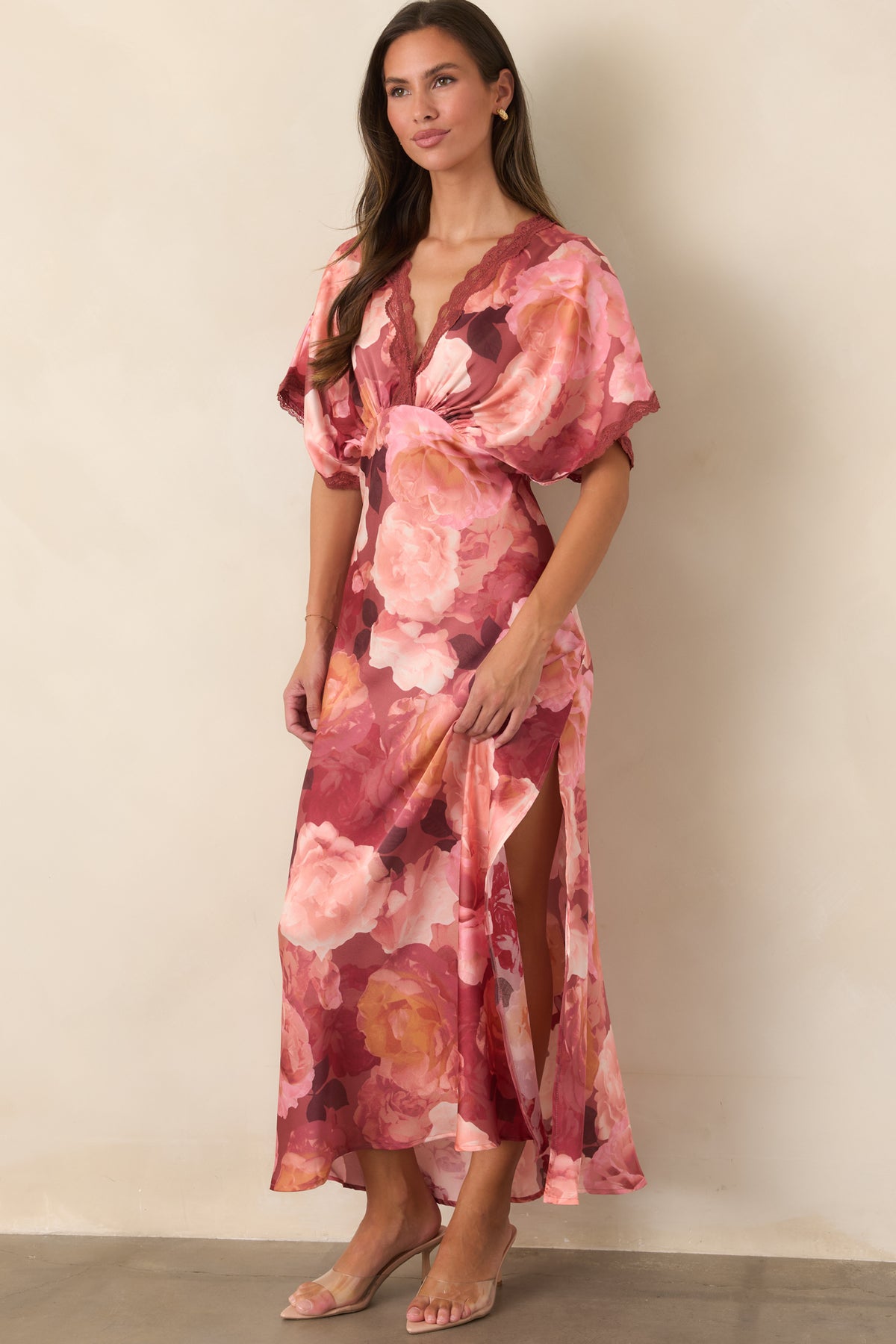 Floral satin maxi dress highlighting its flutter sleeves, lace-trimmed neckline, defined waist, and flowing skirt.