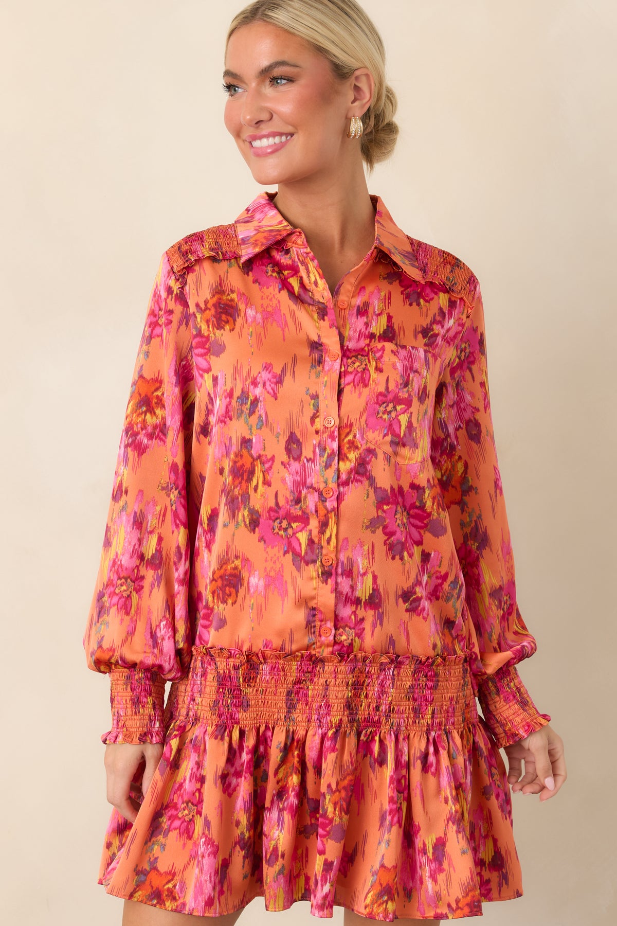Floral satin dress detail featuring the smocked drop waist and softly gathered fabric that releases into the flouncy mini skirt.