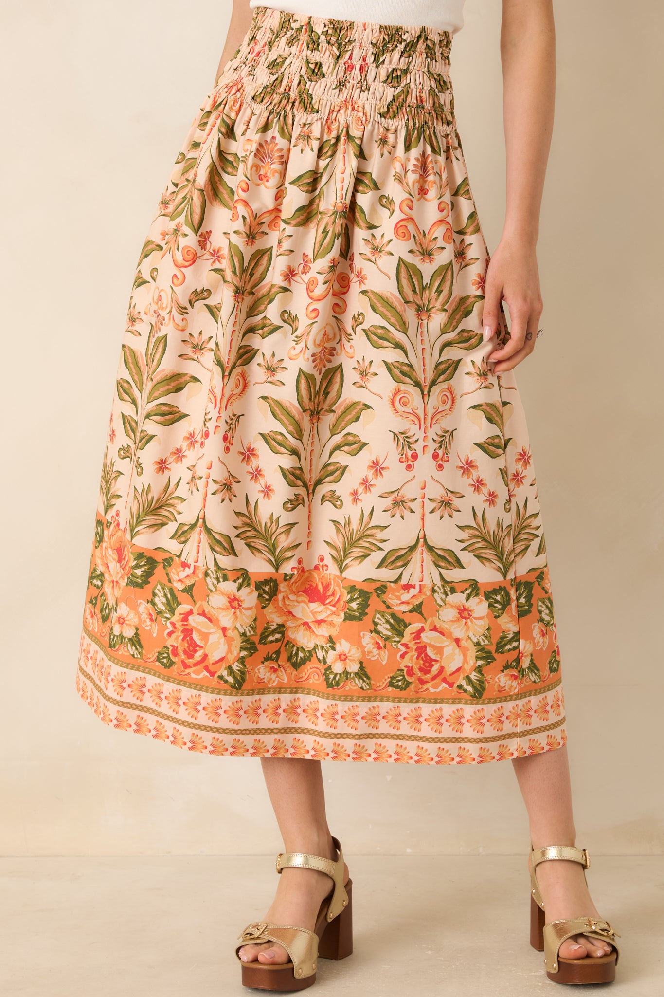 Cropped view of floral skirt highlighting smocked elastic waistband.