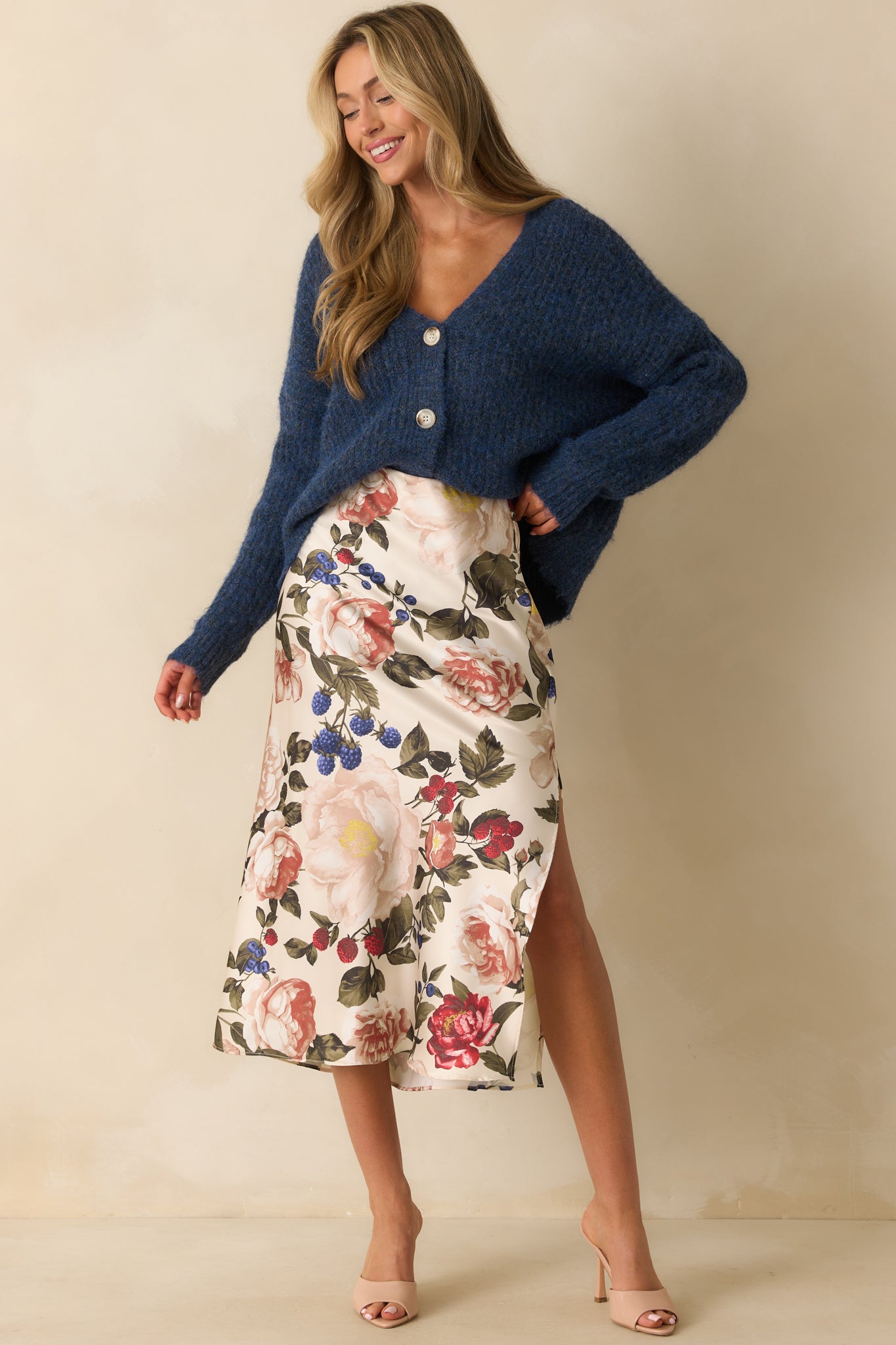 Flowing floral skirt in ivory with elastic waistband and slit accent along the side.