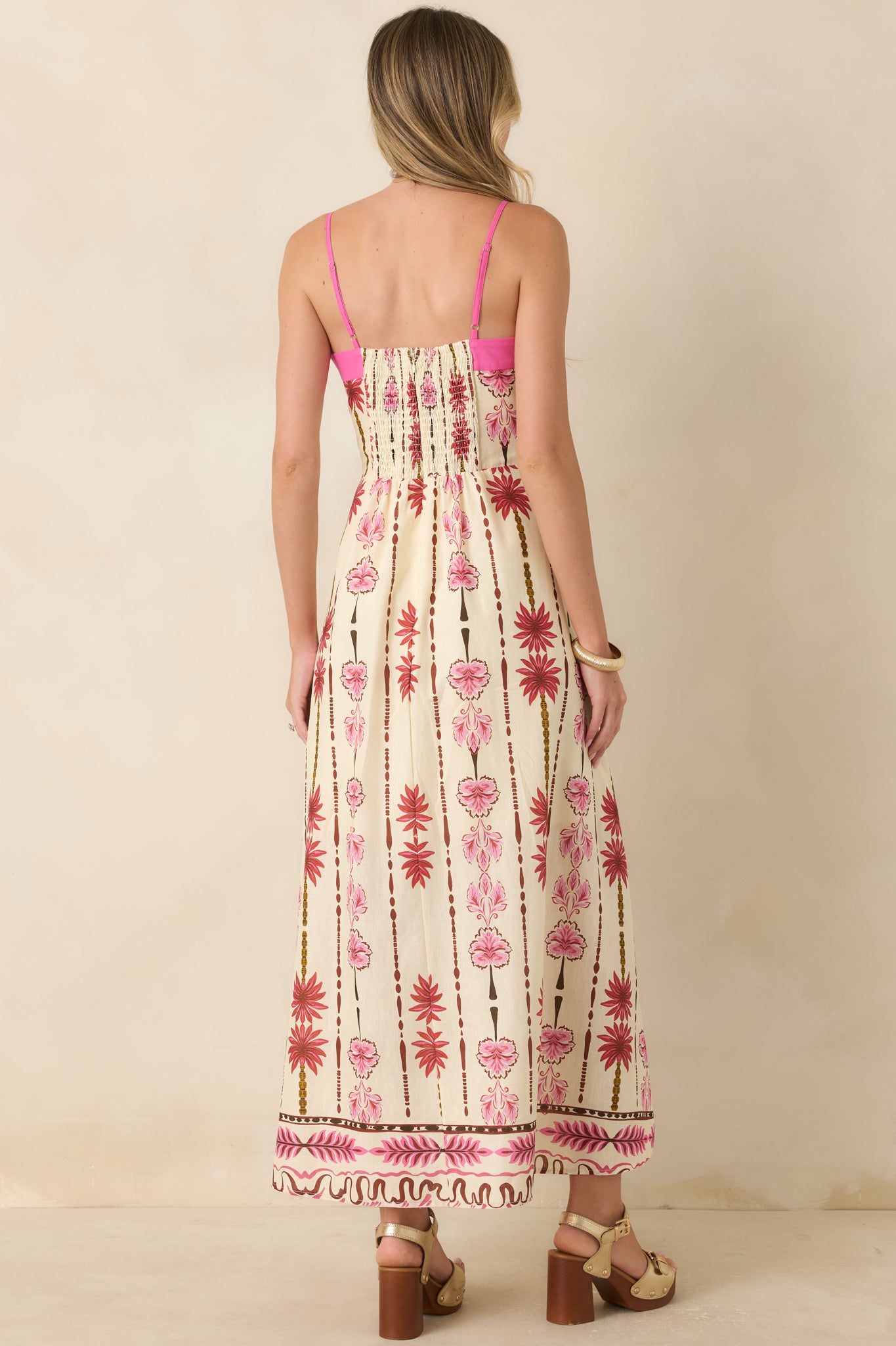 Rear view of the floral cotton linen maxi dress featuring adjustable straps, smocked back panel, and flowing skirt.