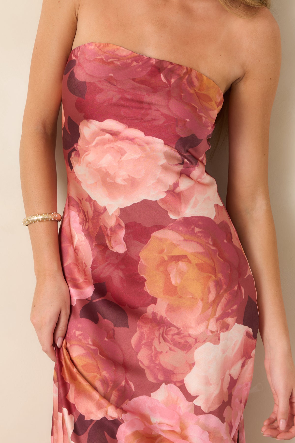 Close-up detail of the strapless neckline, highlighting the elasticized band, interior grip strip, and oversized floral print.