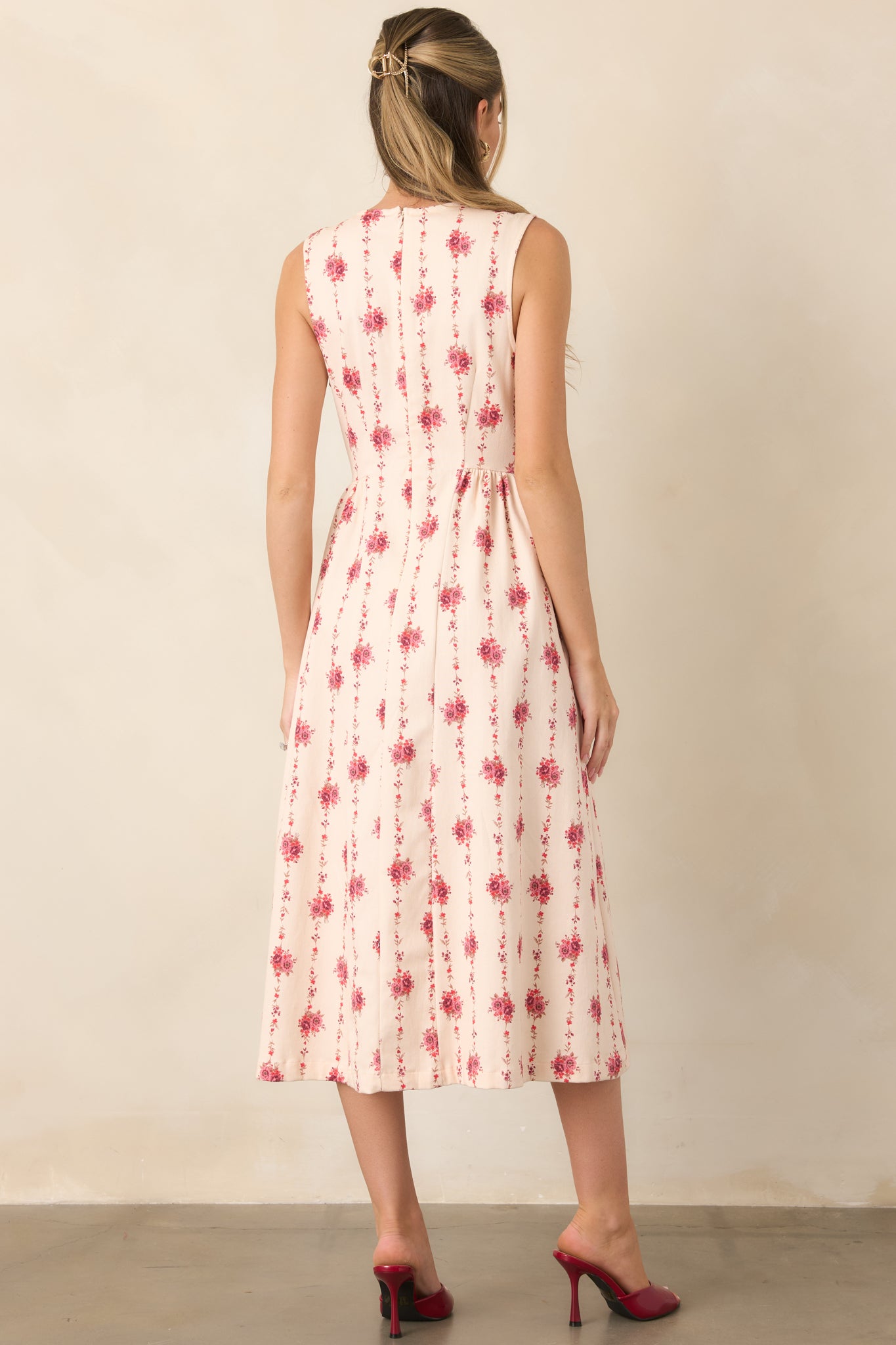 Rear view of the floral stripe midi dress showcasing the fitted bodice, concealed back zipper, and softly flared skirt.
