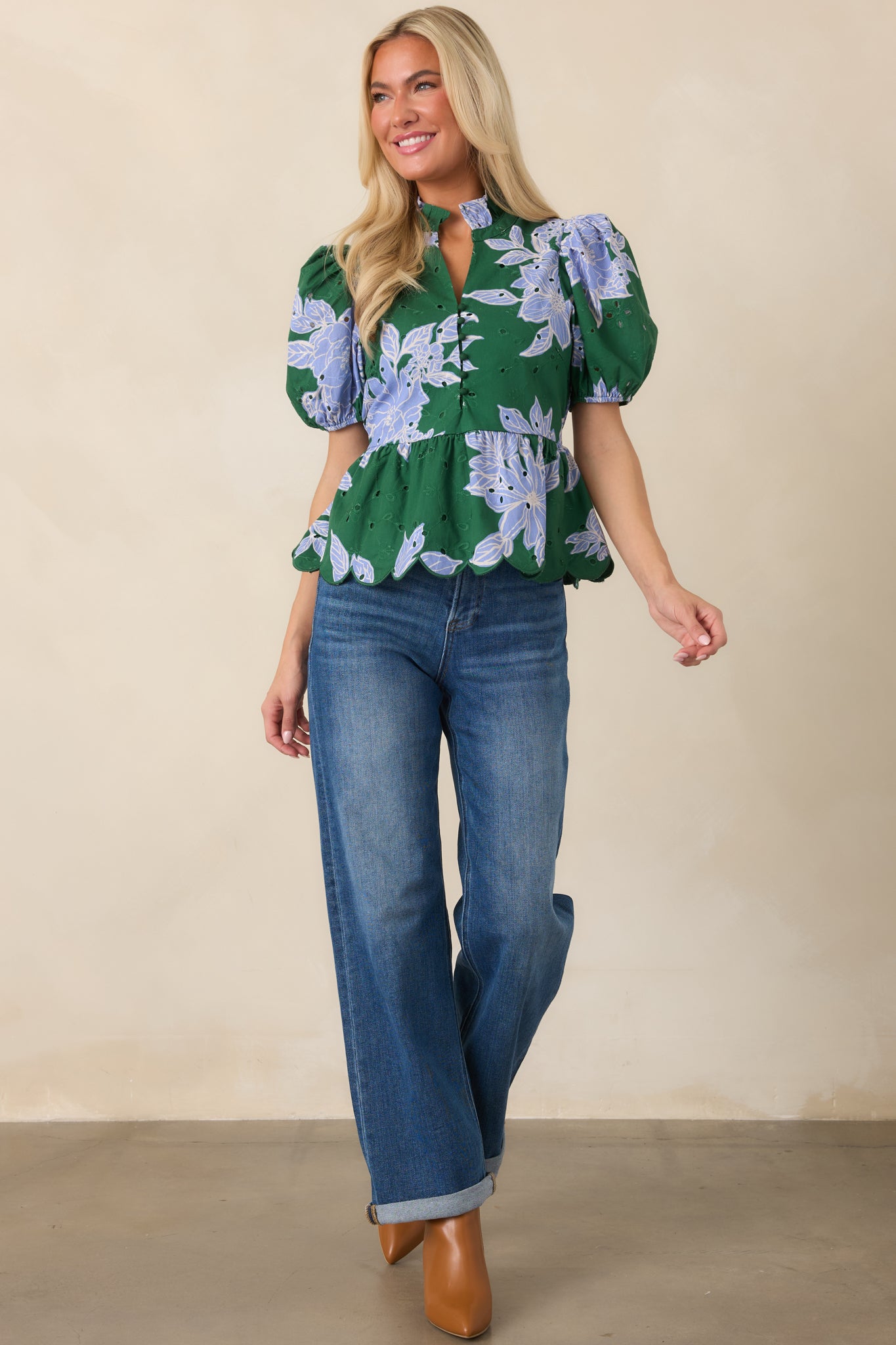 Floral top displaying its eyelet-accented fabric, polished button-front placket, gathered puff sleeves, and flattering waist definition.