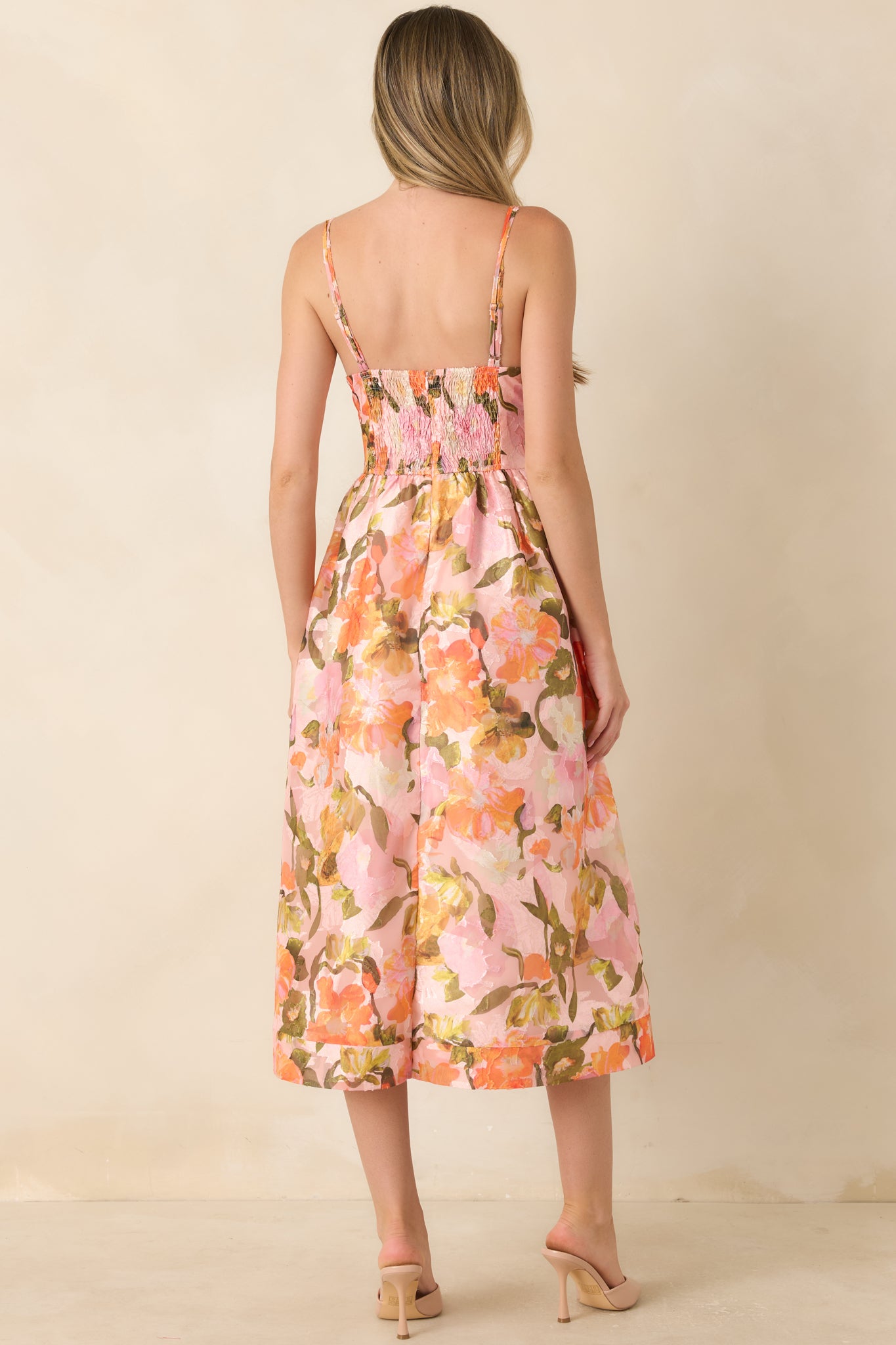 Floral watercolor print midi dress featuring a surplice bodice, adjustable spaghetti straps, defined waist, and softly gathered skirt with side pockets.