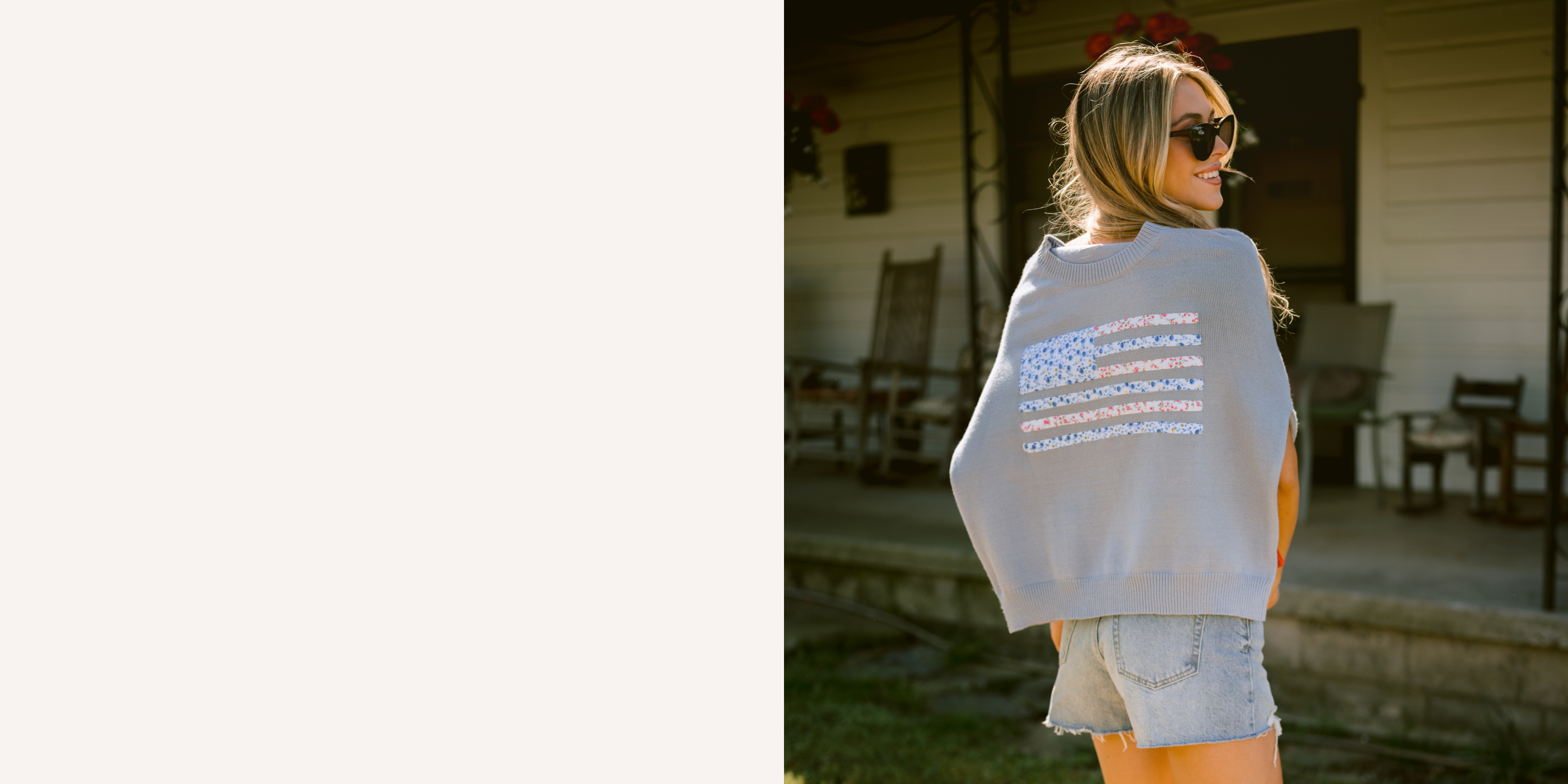 Woman wearing a light blue sweater over her shoulders, with a floral designed American flag outdoors.