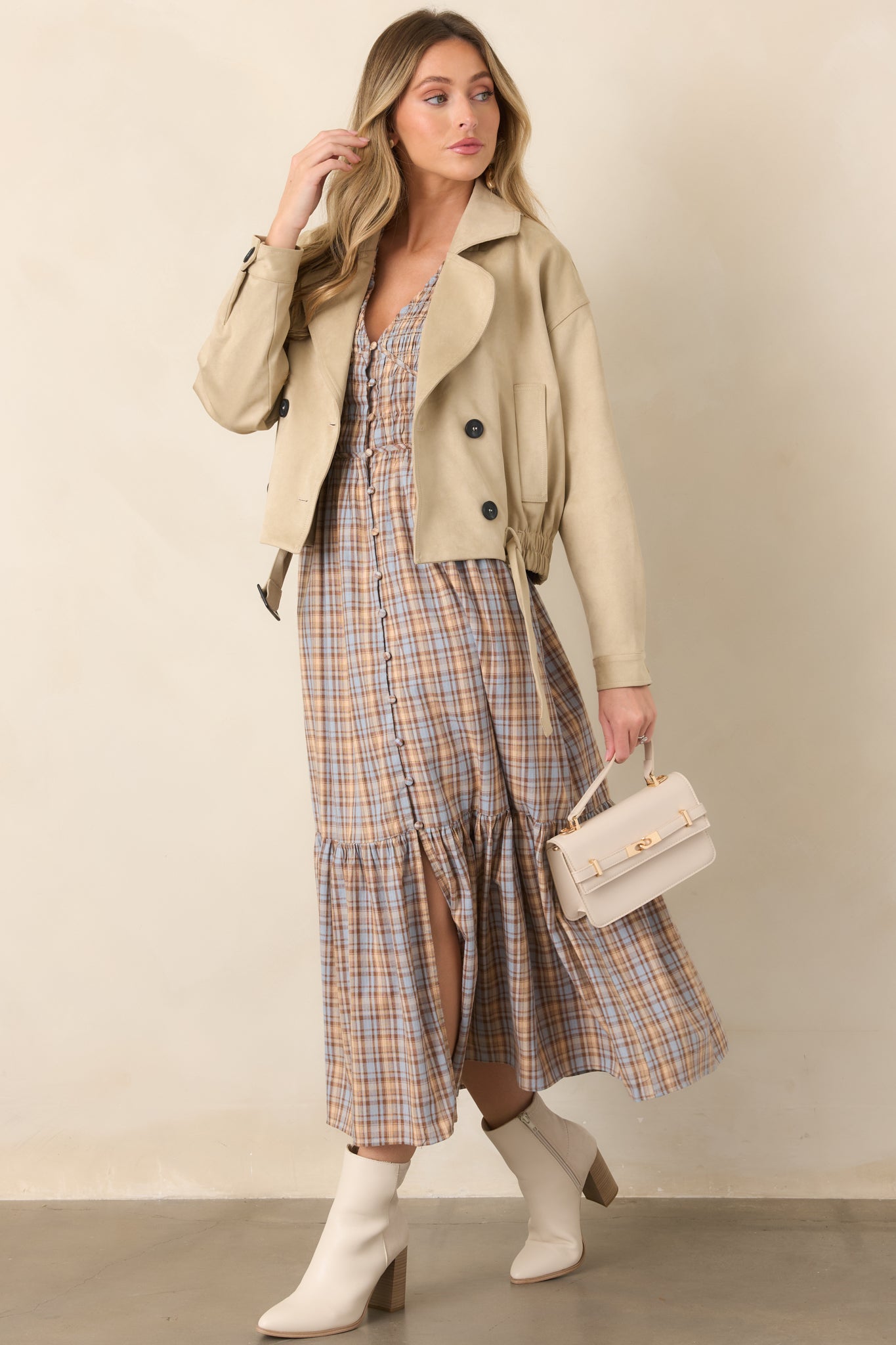 Flowing cotton midi dress with a softly gathered skirt, deep V-neckline, flutter sleeves, covered buttons, and practical side pockets.