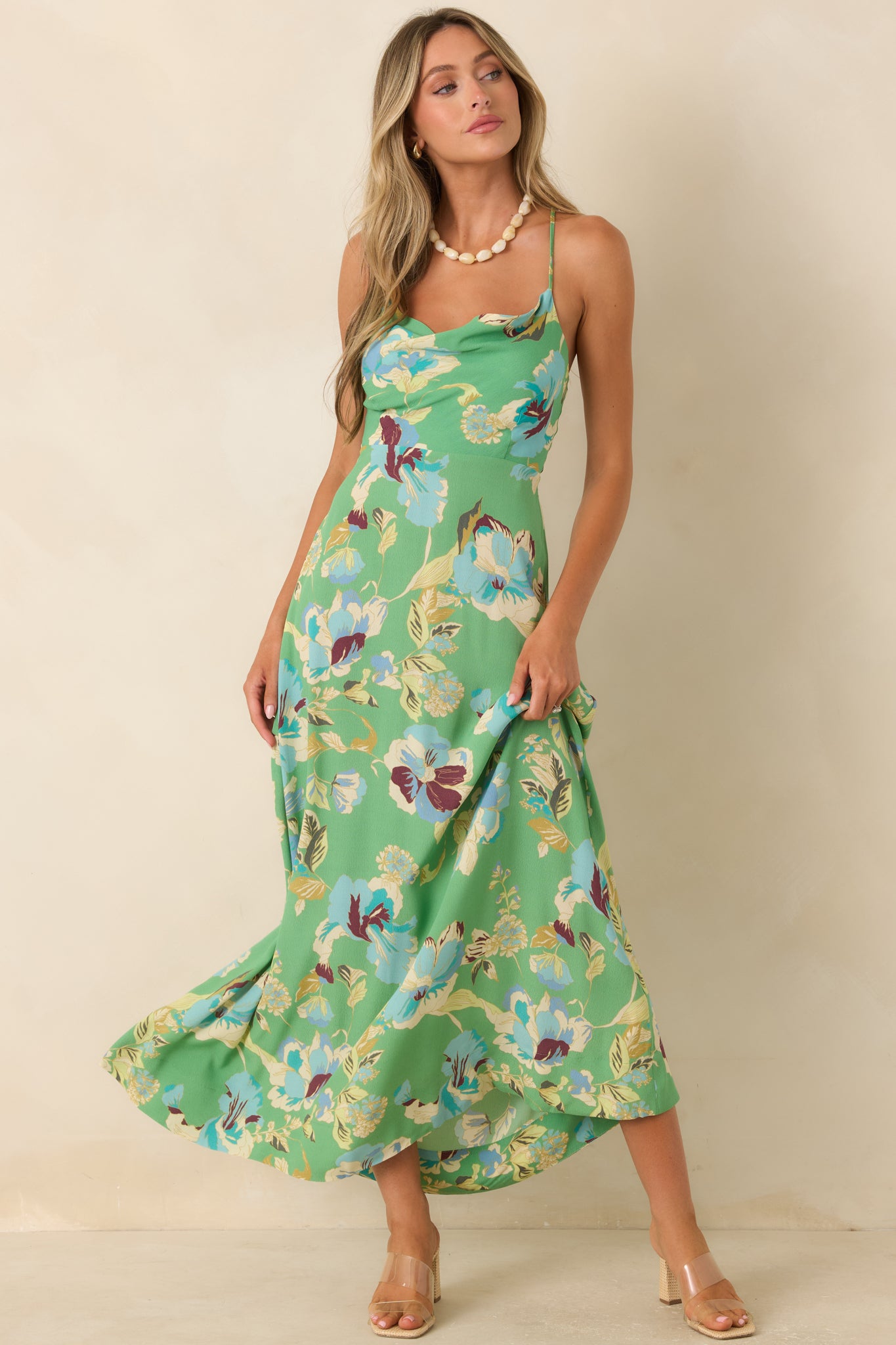 Flowing floral maxi dress with adjustable spaghetti straps, a graceful silhouette, and lightweight fabric.