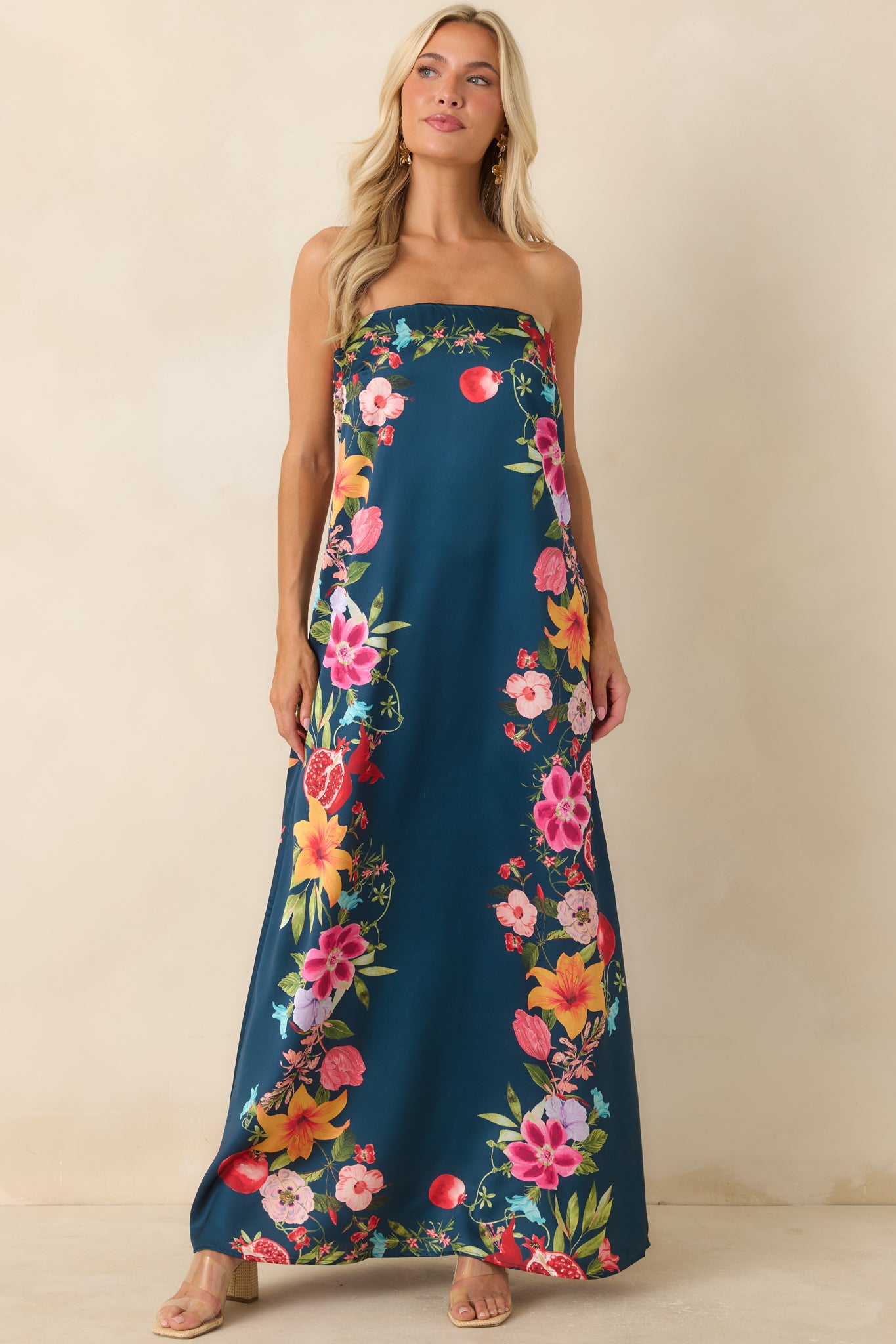 Flowing navy maxi dress with a colorful border pattern, secure strapless neckline, and relaxed full-length silhouette.