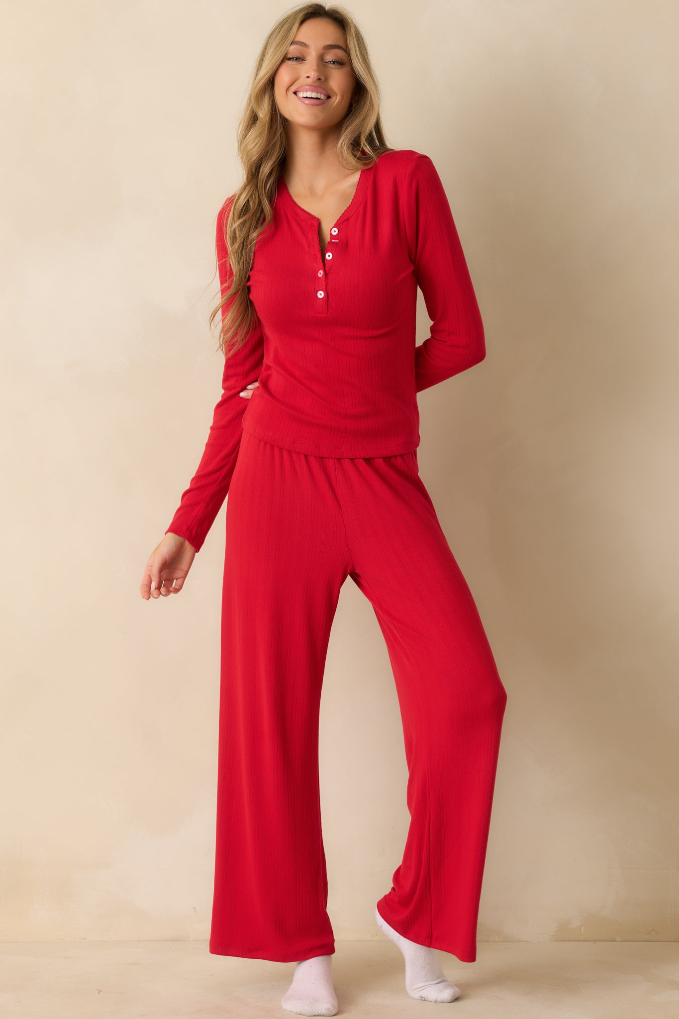 Flowing red wide-leg pants in pointelle knit, showcasing the elastic waistband and comfortable fit.