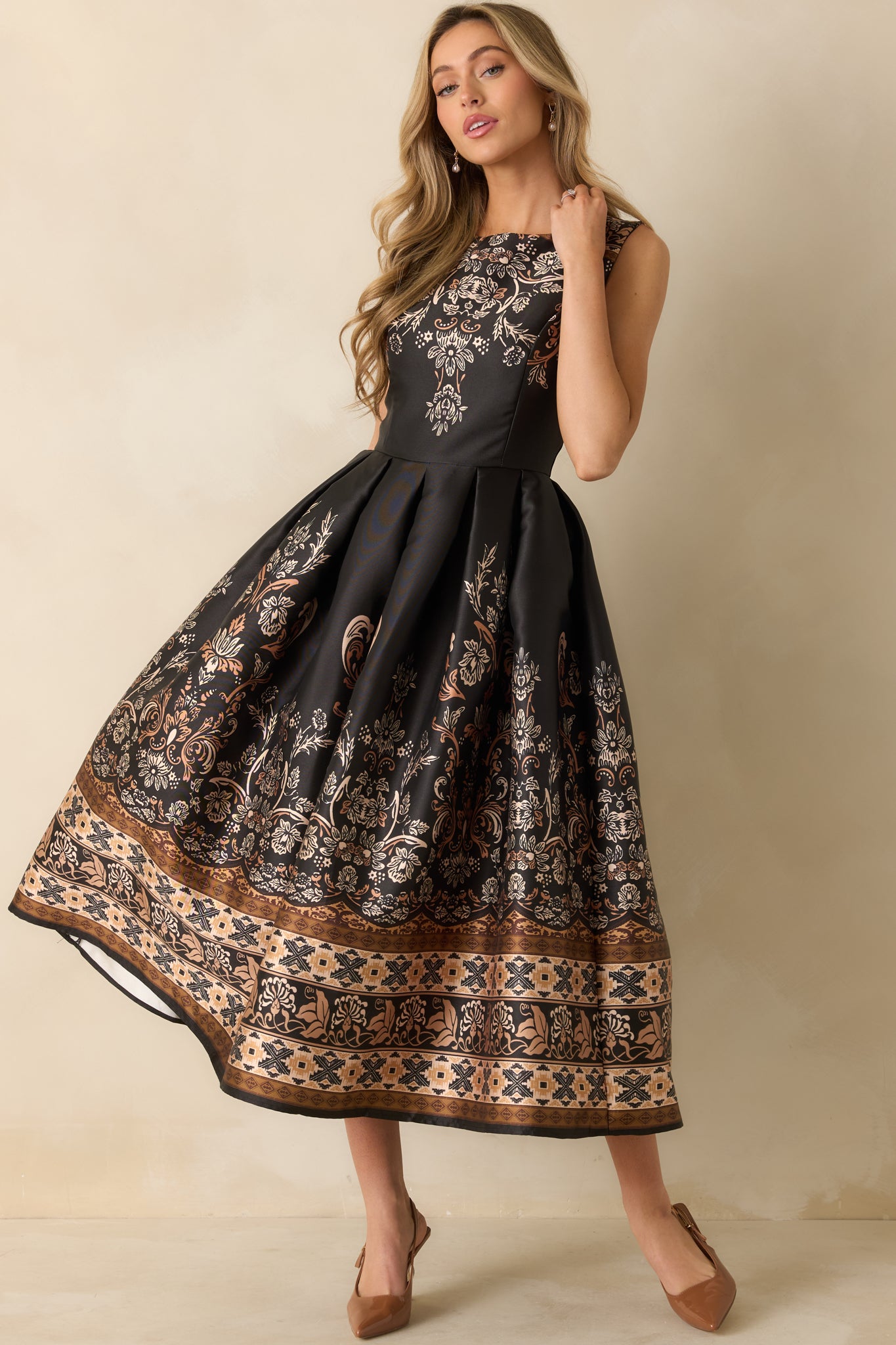 An angled full-length shot showcasing the flowing pleated skirt and maxi length.