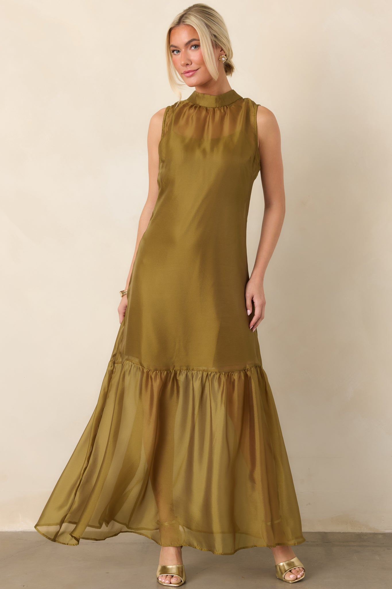 Flowing sheer maxi dress showcasing a delicate organza overlay, streamlined high neckline, and layered skirt with a shorter slip lining.