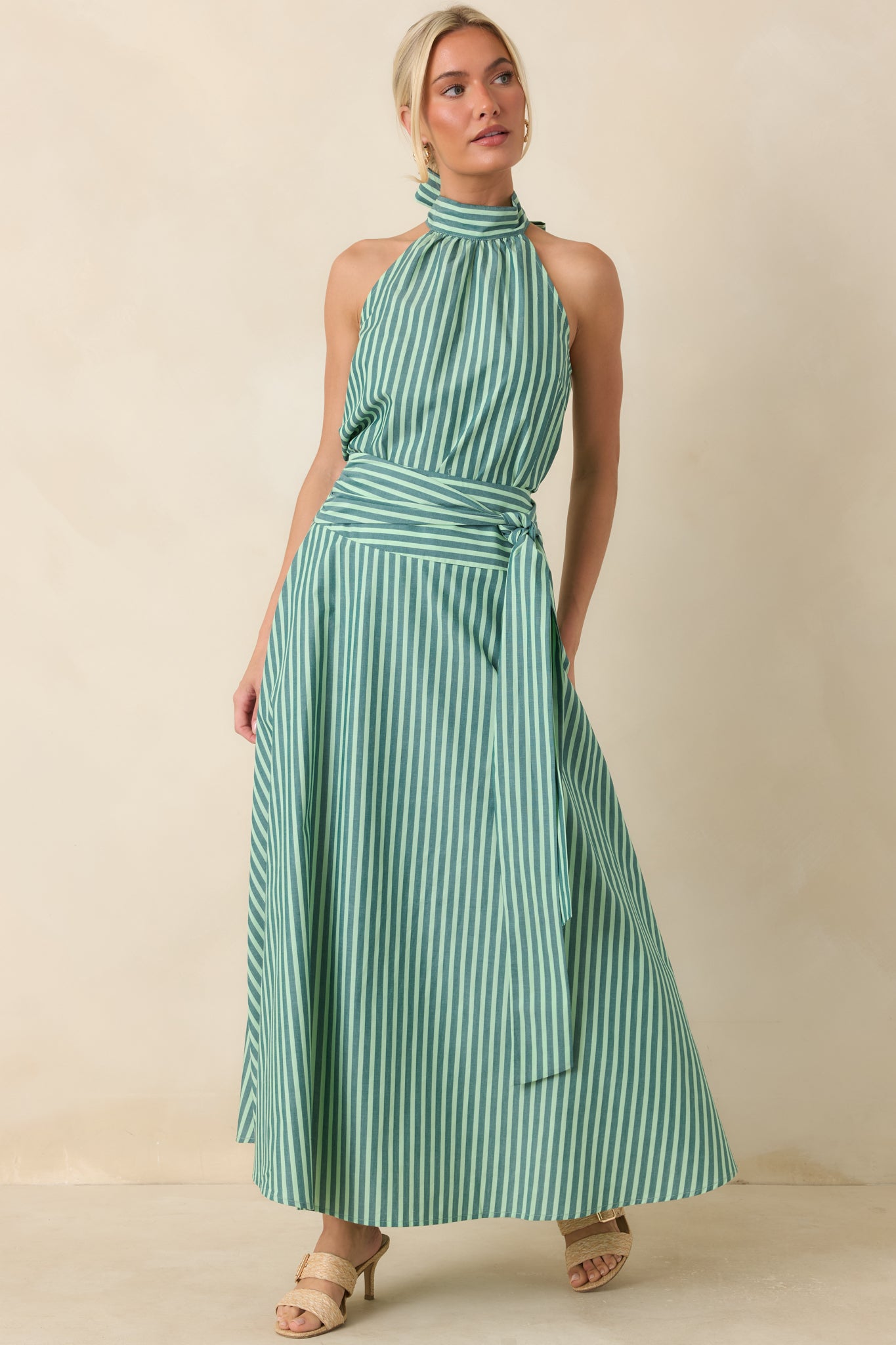 Lightweight striped halter top designed with a flowing fit, high neckline, and soft gathering that creates graceful movement throughout the silhouette.