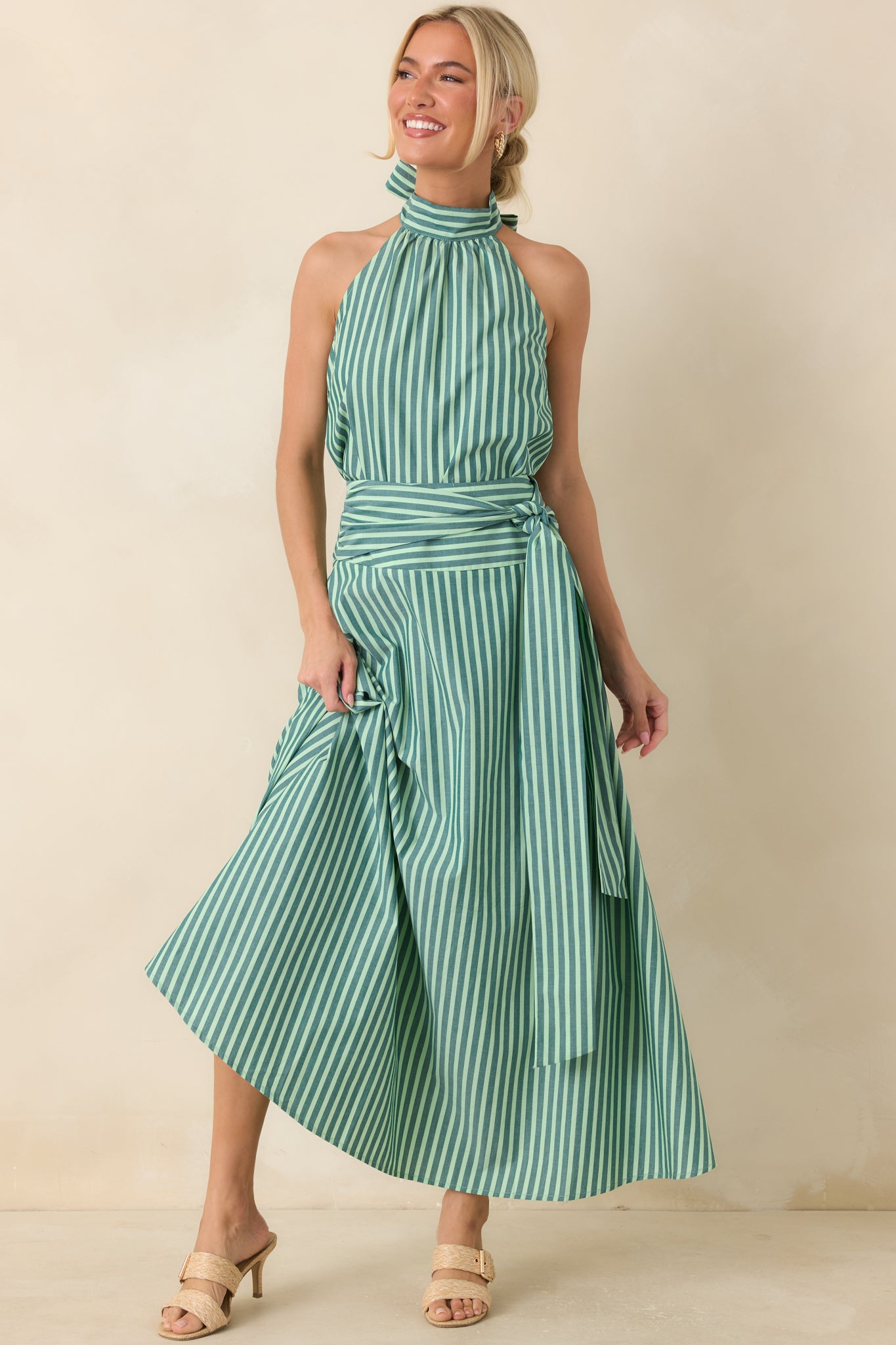 Flowy cotton maxi skirt showcasing a flattering high-rise fit, oversized waist tie, and thoughtfully placed stripes throughout the full silhouette.