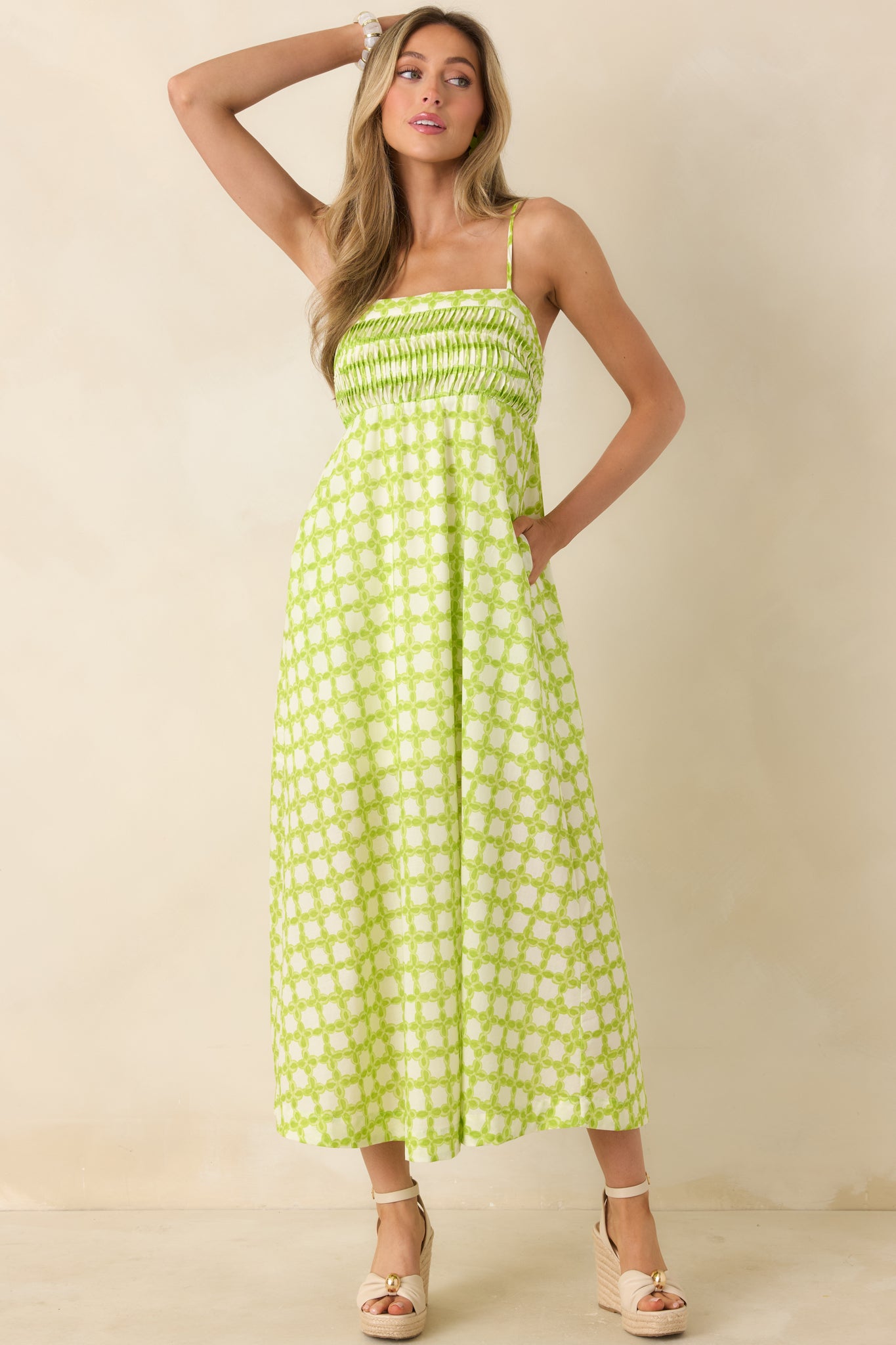 Flowy cotton midi dress with a structured pleated bodice and delicate adjustable straps.