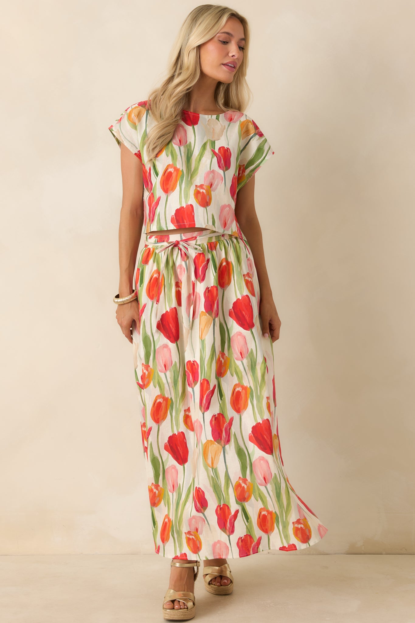 Flowy ivory floral midi skirt with red tulip patterns, a comfortable elastic waistband, and lightweight linen blend fabric.