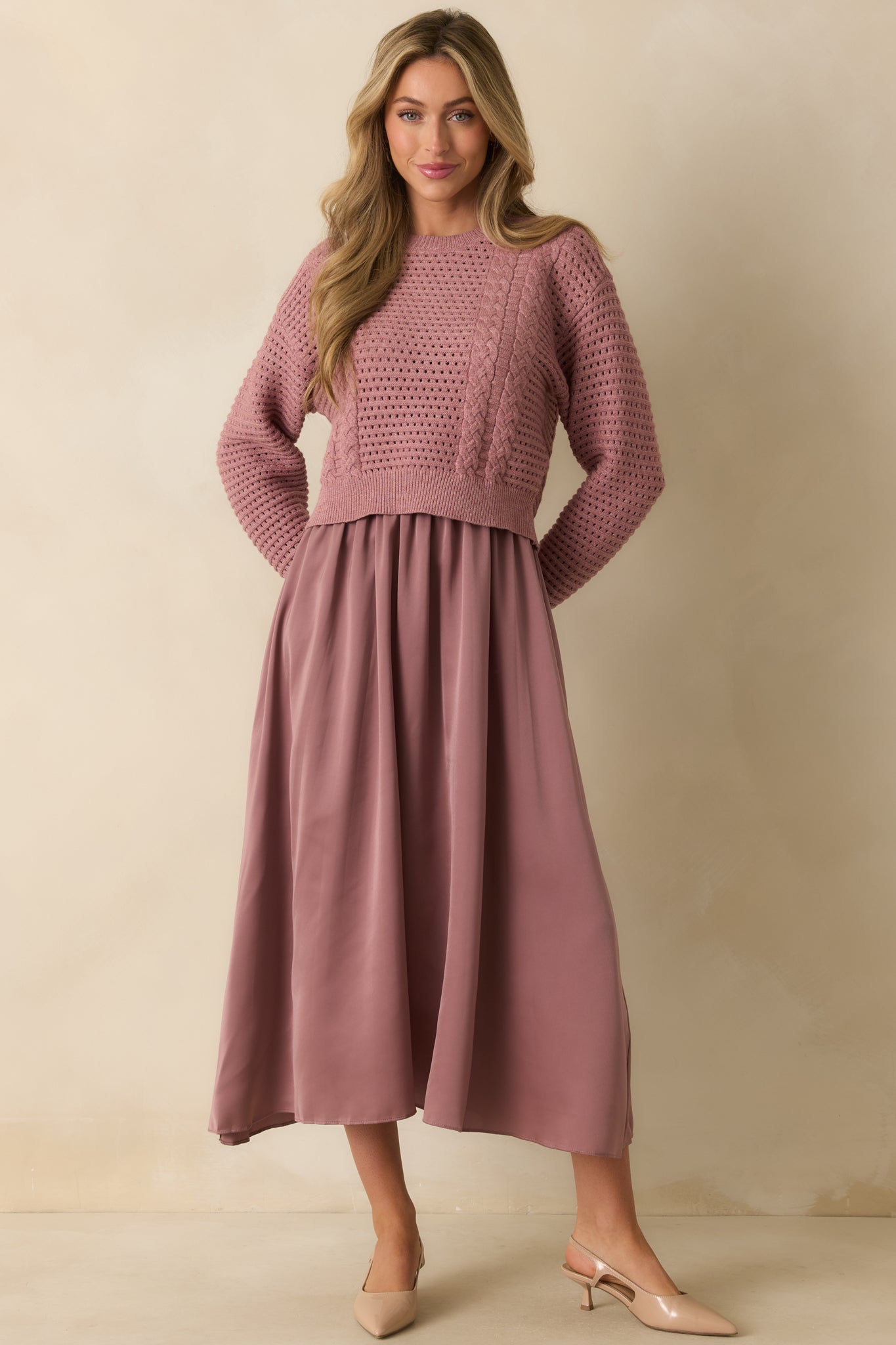 Flowy mauve maxi dress with an elastic waist and subtle sheen, paired with a textured open-knit top.