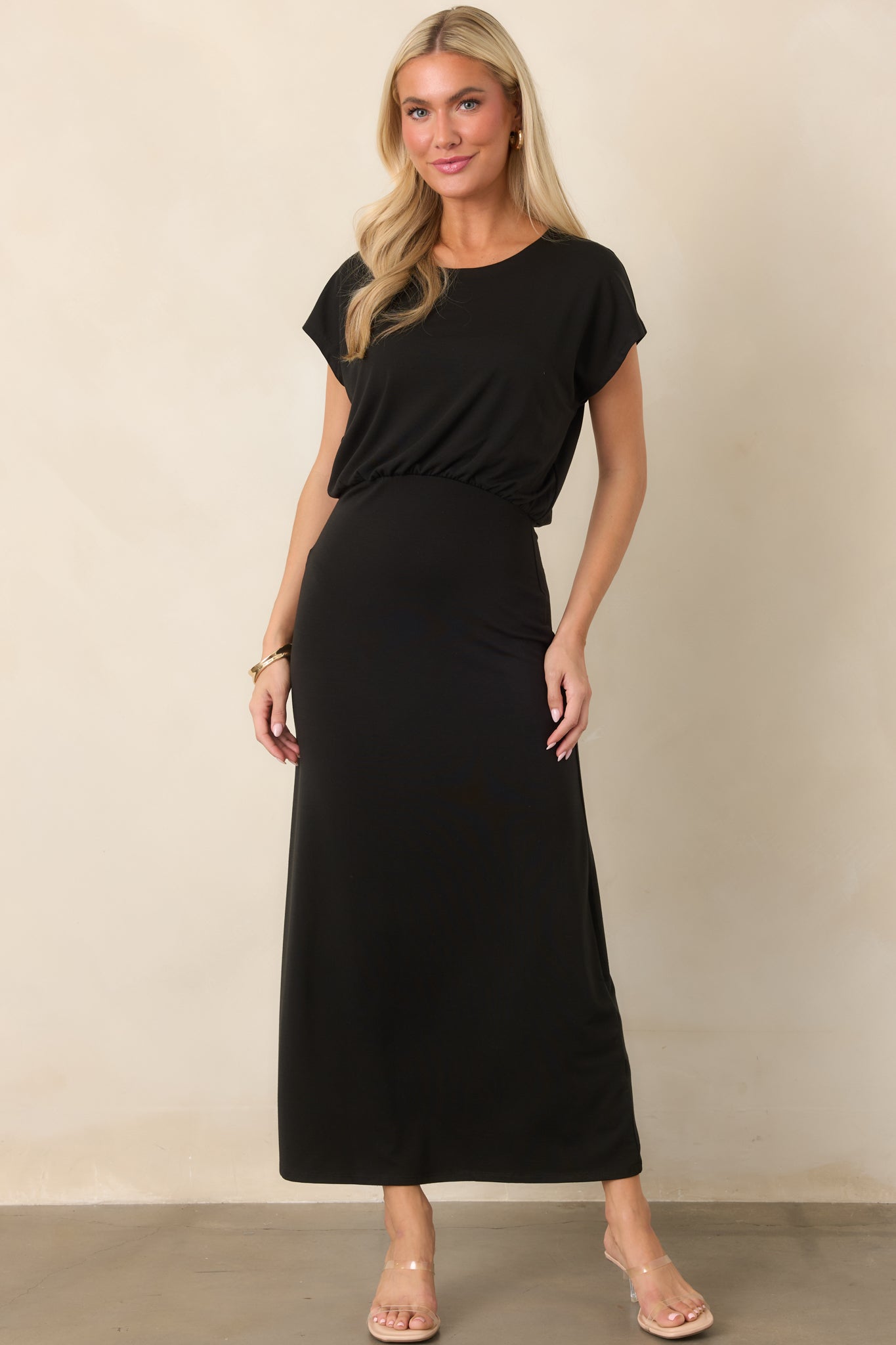 Fluid jersey dress with a relaxed blouson bodice, defined waist gathering, short sleeves, and an elegant midi-length skirt.
