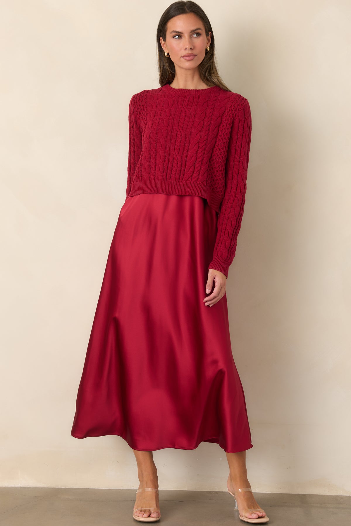 Fluid satin maxi dress creating a softly draped A-line silhouette beneath a textured cropped sweater.