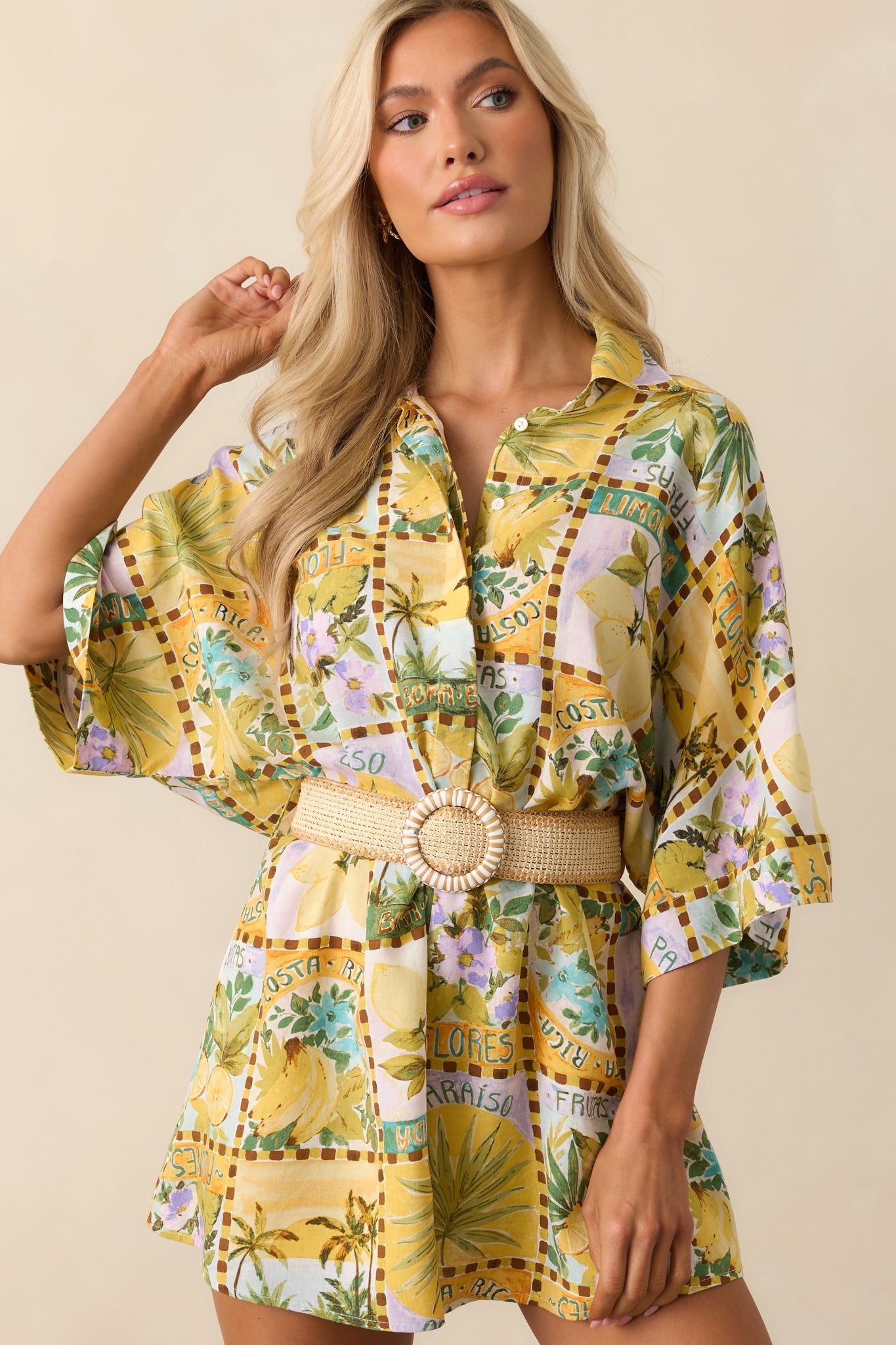 Midsection view focusing on the belted waist and functional belt loops of the tropical print romper