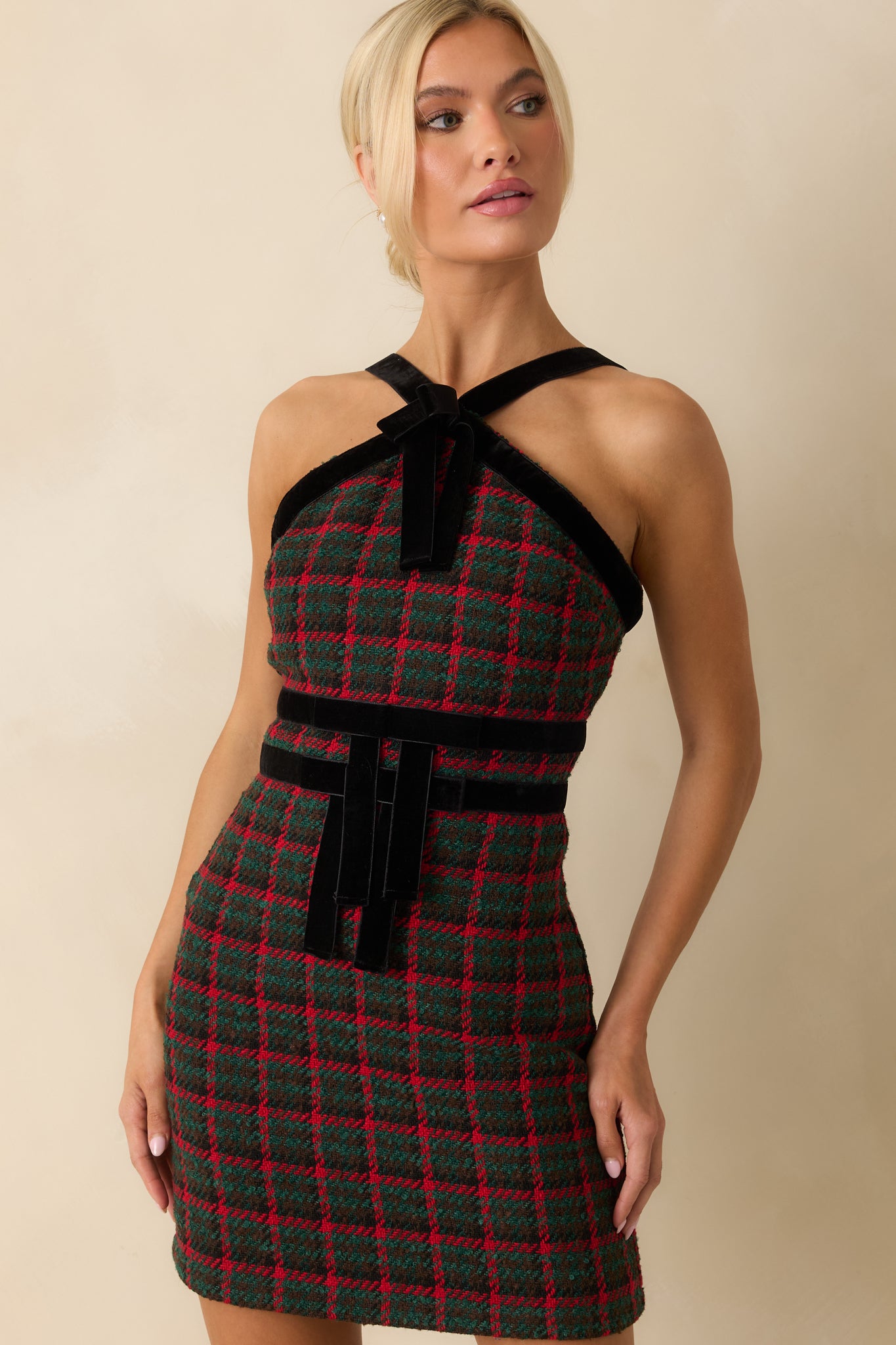 Focused look at the adjustable velvet straps and trim framing the top of the plaid tweed design.
