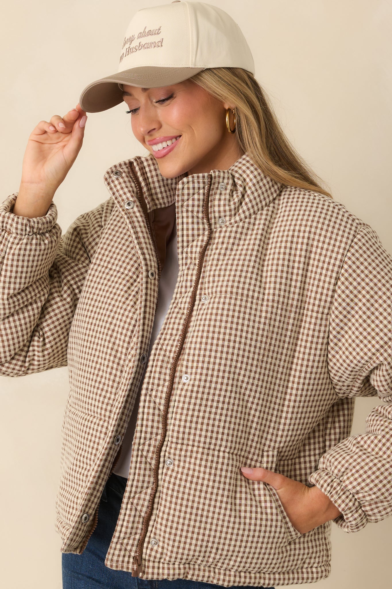 Focused view of the brown gingham quilted pattern and high neckline details.