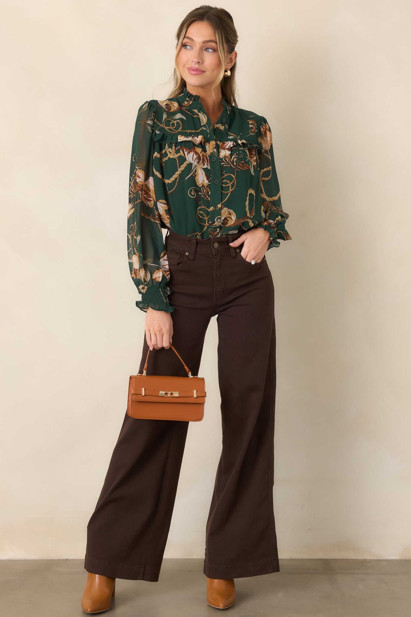 Forest green button-front blouse with a softly gathered neckline, relaxed fit, and delicate ruffle detailing across the yoke.