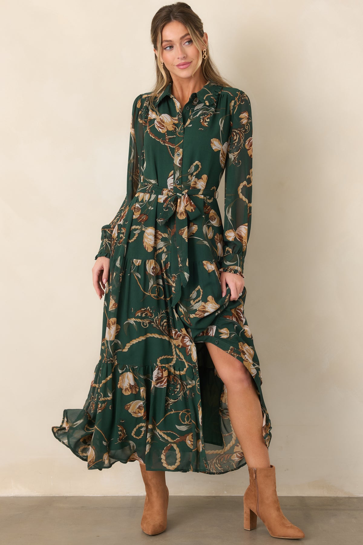Forest green floral maxi dress featuring a classic collar, functional button-front closure, self-tie waist, sheer long sleeves, and tiered flowing skirt.