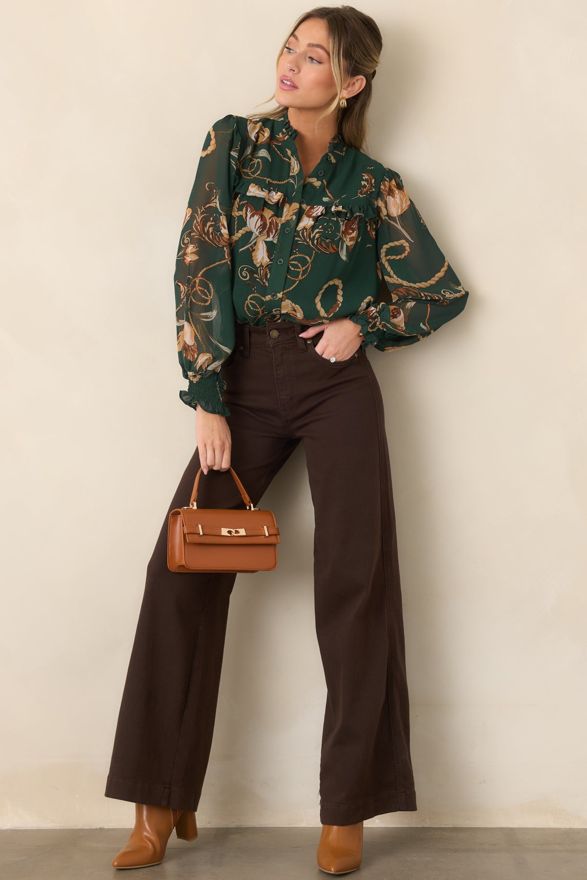 Forest green blouse featuring a relaxed silhouette, ruffled neckline, functional button-down front, and long sheer sleeves with smocked cuffs.